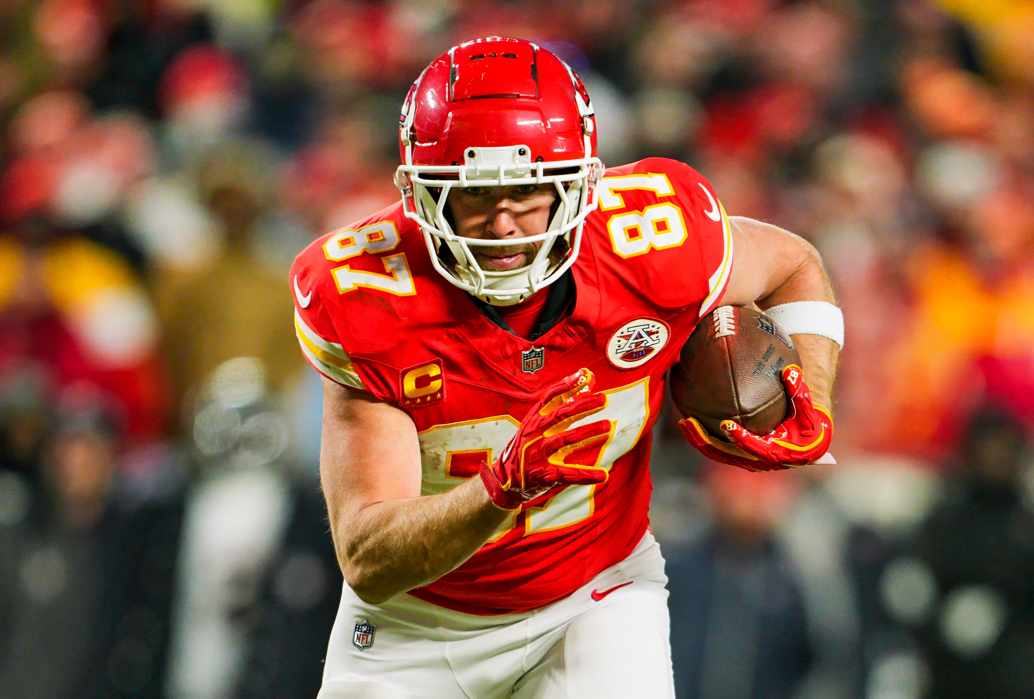 Jan 18, 2025; Kansas City, Missouri, USA; Kansas City Chiefs tight end Travis Kelce (87) runs with the ball during the second half against Houston Texans in a 2025 AFC divisional round game at GEHA Field at Arrowhead Stadium. 