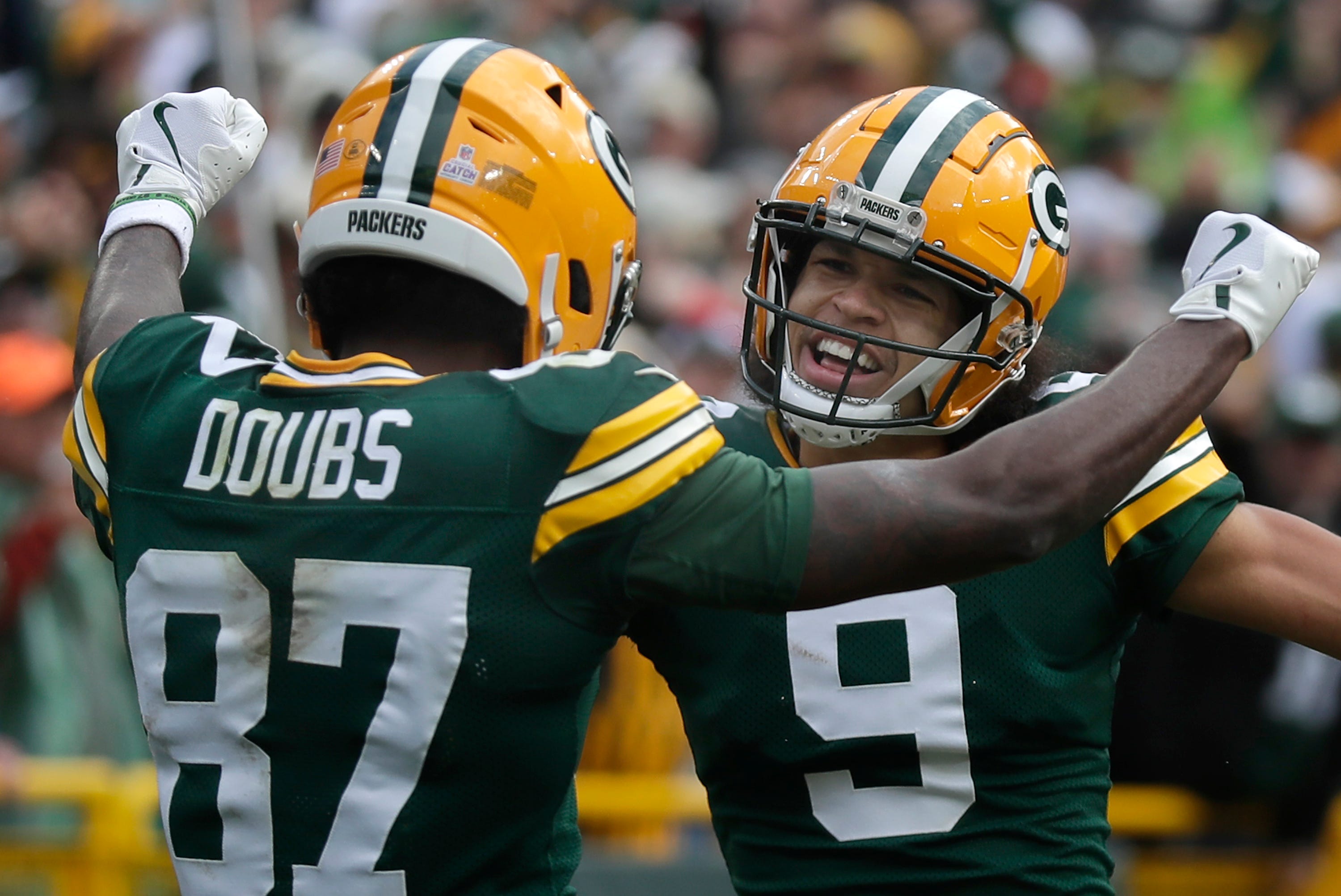 Green Bay Packers wide receiver Romeo Doubs (87) celebrates with wide receiver Christian Watson (9) after catching a touchdown pass against the Arizona Cardinals on Sunday, October 13, 2024 at Lambeau Field in Green Bay, Wis.
