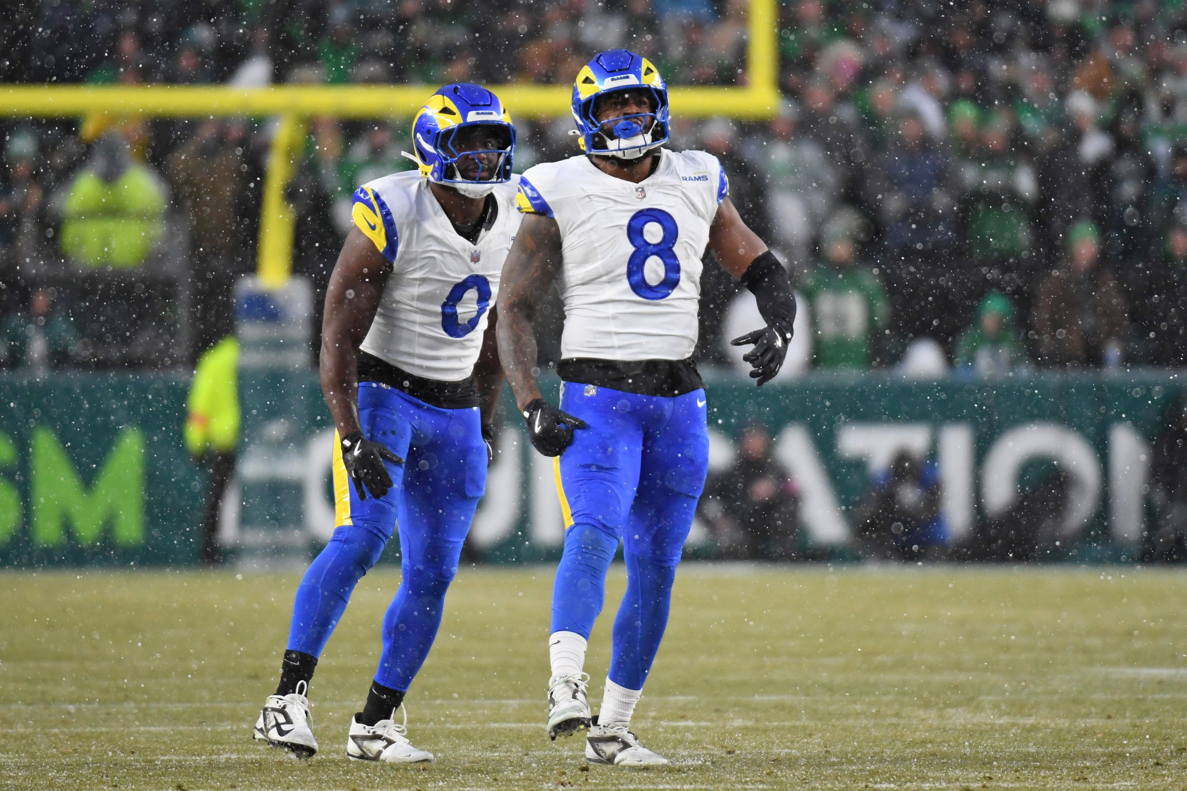 Jan 19, 2025; Philadelphia, Pennsylvania, USA; Los Angeles Rams linebacker Byron Young (0) and linebacker Jared Verse (8) celebrate a sack against the Philadelphia Eagles in a 2025 NFC divisional round game at Lincoln Financial Field.