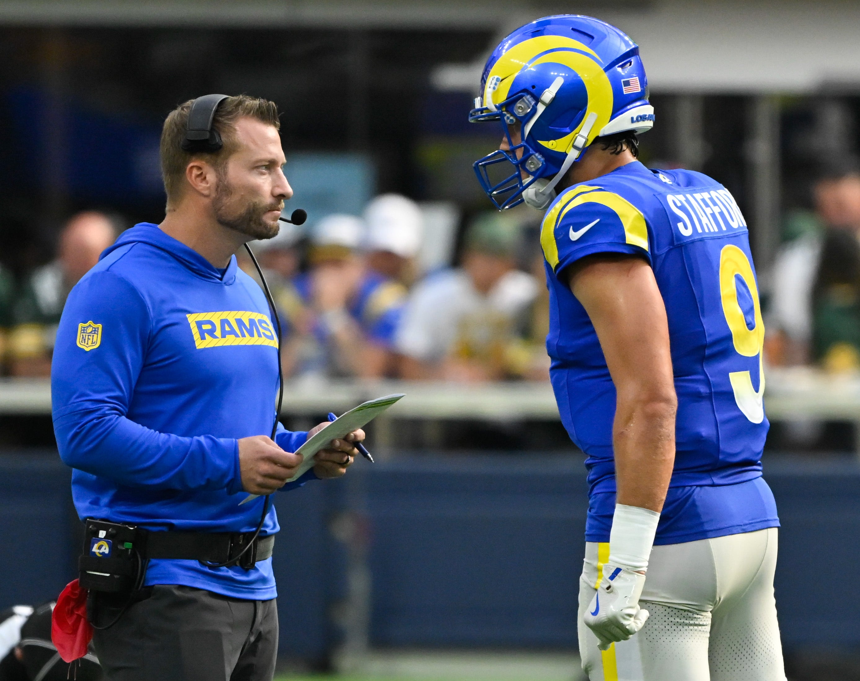 Los Angeles Rams head coach Sean McVay talks to quarterback Matthew Stafford (9) during the third quarter against the Green Bay Packers at SoFi Stadium.