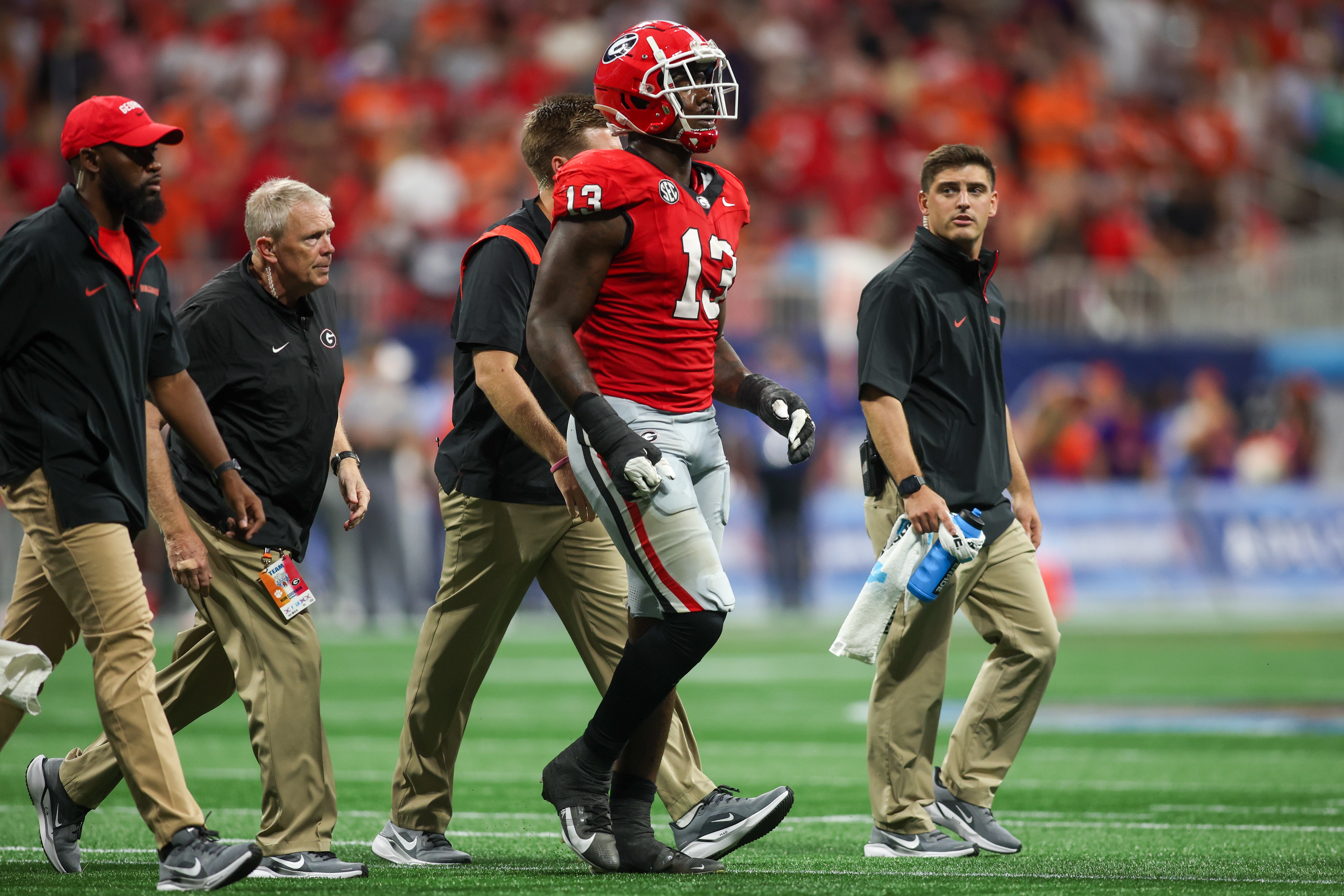 Georgia Bulldogs defensive lineman Mykel Williams (13) goes off the field with an injury against the Clemson Tigers in the third quarter at Mercedes-Benz Stadium.