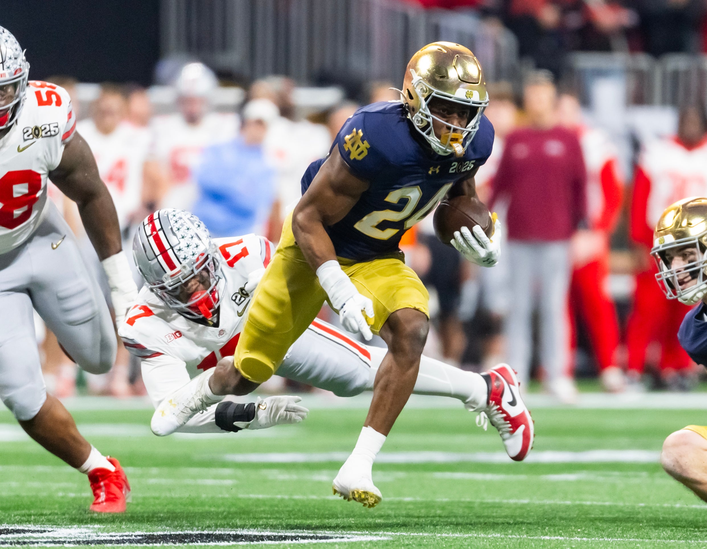 Notre Dame Fighting Irish running back Jadarian Price (24) against the Ohio State Buckeyes during the CFP National Championship college football game at Mercedes-Benz Stadium.