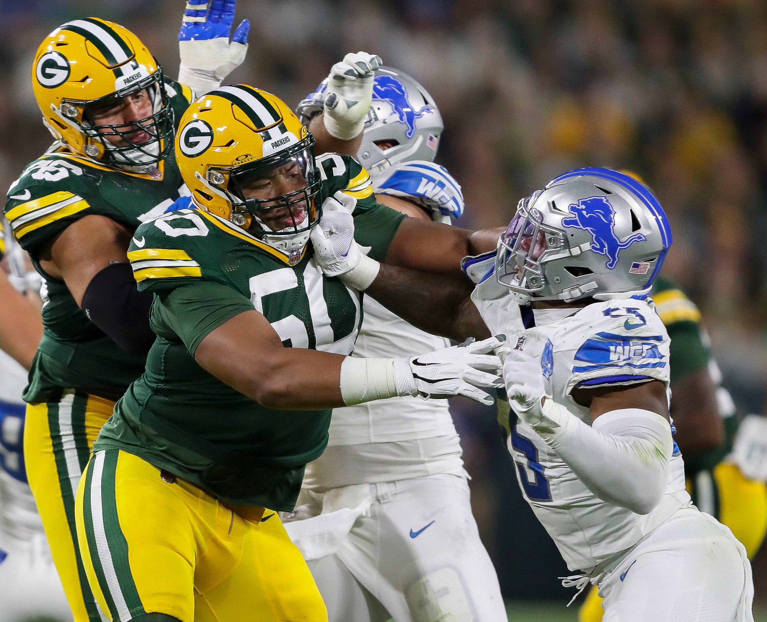 Green Bay Packers guard Zach Tom (50) blocks Detroit Lions linebacker Derrick Barnes (55) during their football game on Thursday, September 28, 2023, at Lambeau Field in Green Bay, Wis.