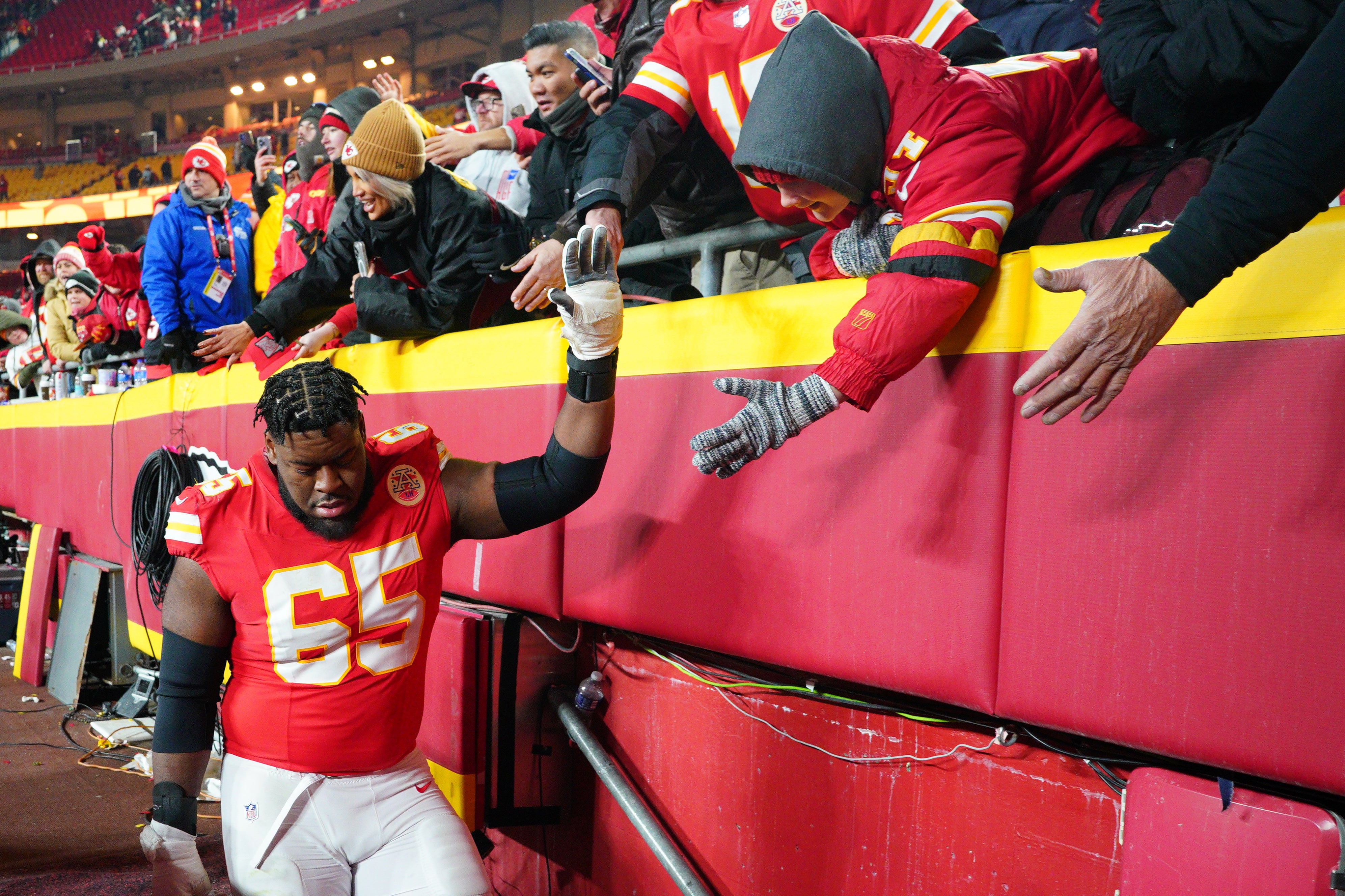 Jan 18, 2025; Kansas City, Missouri, USA; Kansas City Chiefs guard Trey Smith (65) greets fans while leaving the field after a 2025 AFC divisional round game against the Houston Texans at GEHA Field at Arrowhead Stadium.