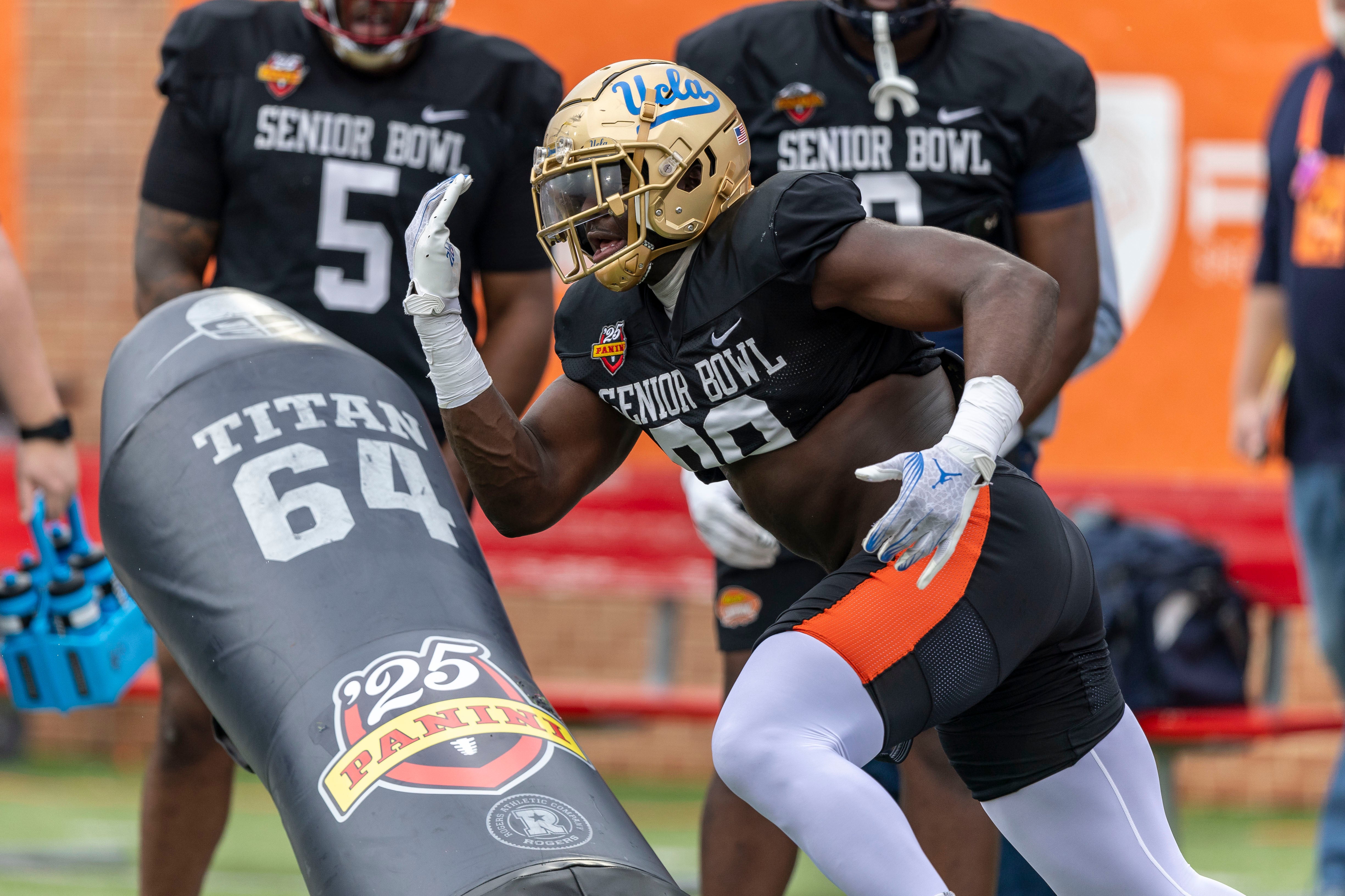 Jan 30, 2025; Mobile, AL, USA; National team defensive lineman Oluwafemi Oladejo of UCLA (99) works through drills during Senior Bowl practice for the National team at Hancock Whitney Stadium.