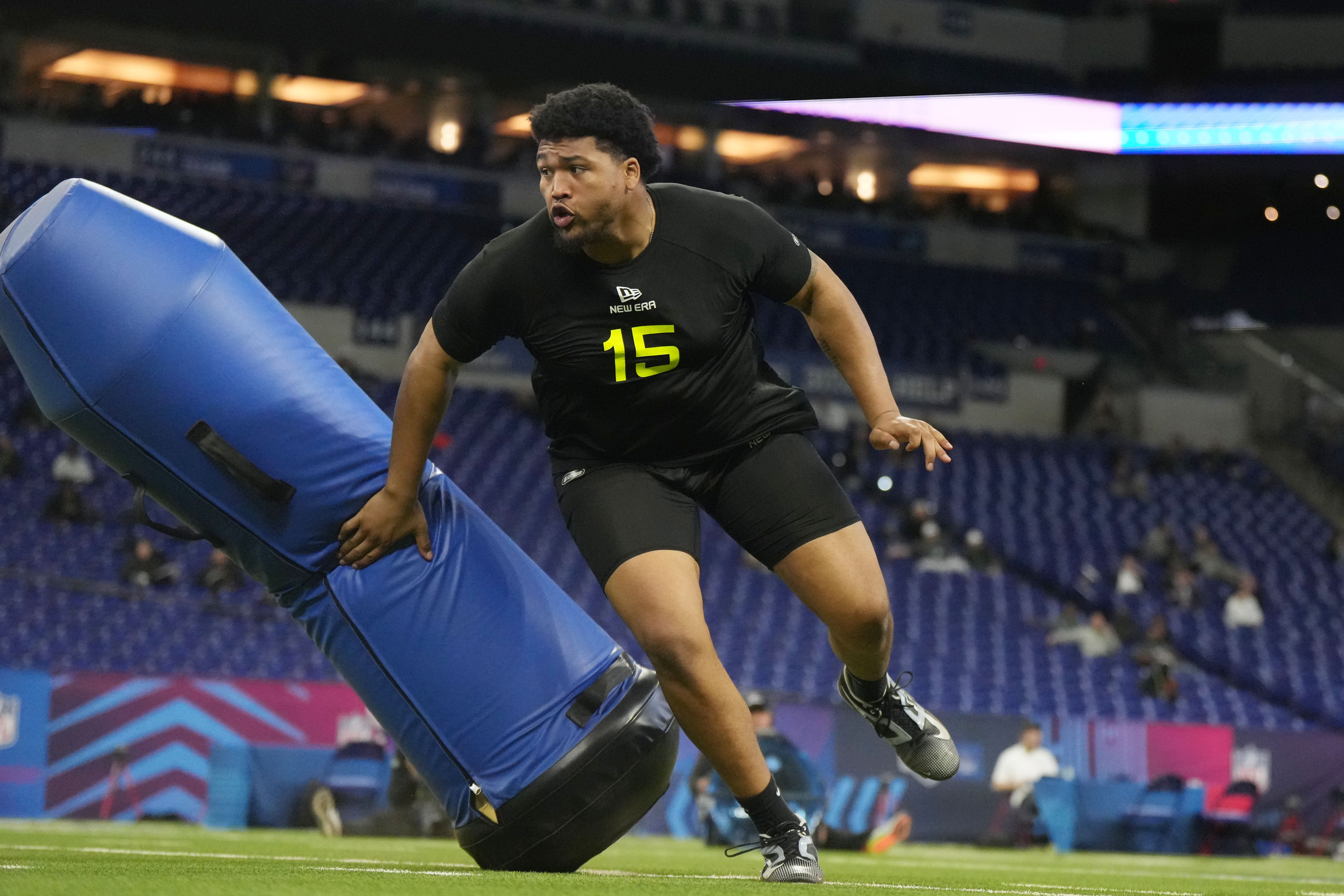 Derrick Harmon (15) does drills at the NFL Scouting Combine at Lucas Oil Stadium in Indianapolis, Indiana.