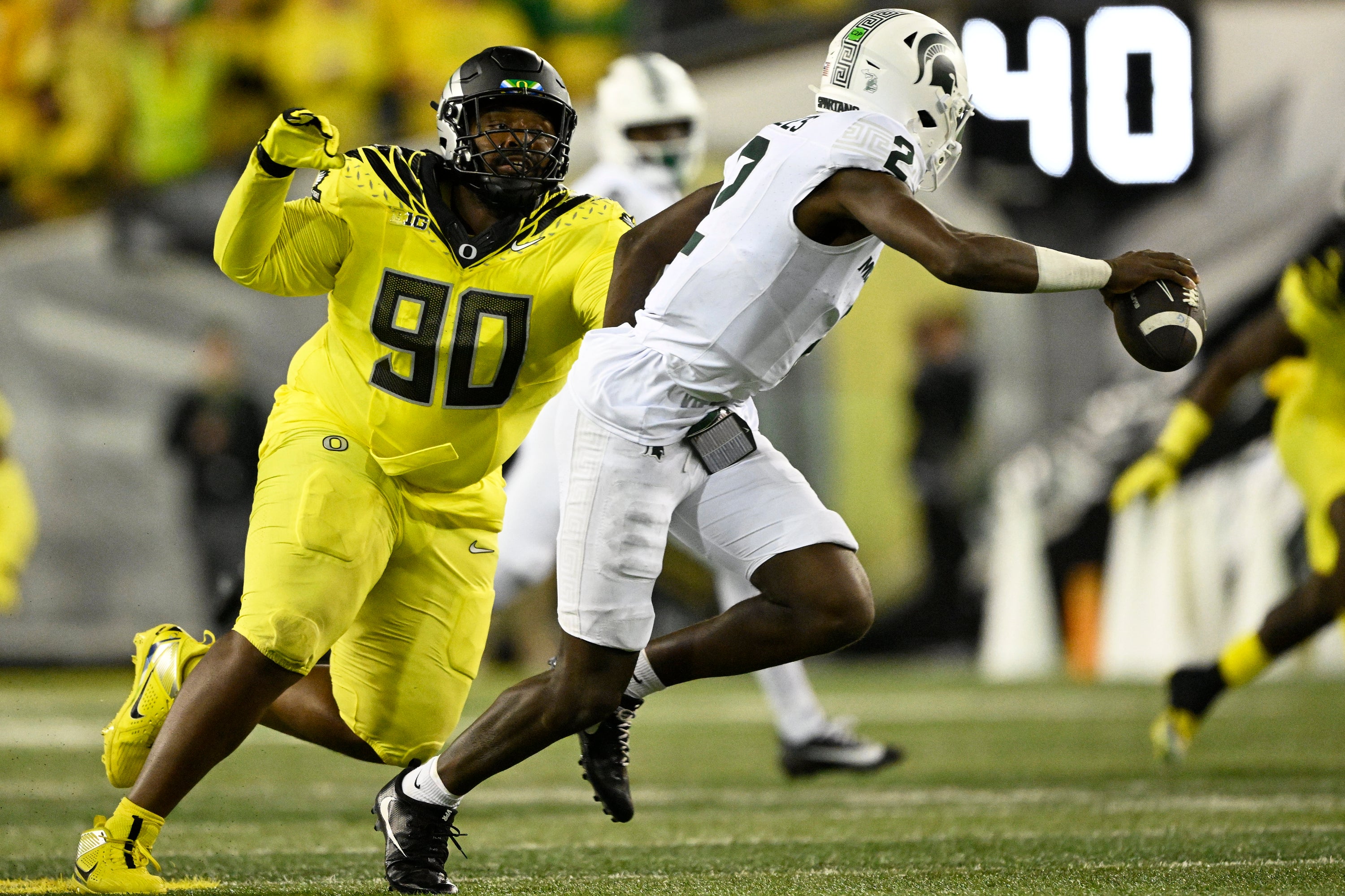Oct 4, 2024; Eugene, Oregon, USA; Oregon Ducks defensive lineman Jamaree Caldwell (90) chases after Michigan State Spartans quarterback Aidan Chiles (2) during the second half at Autzen Stadium.