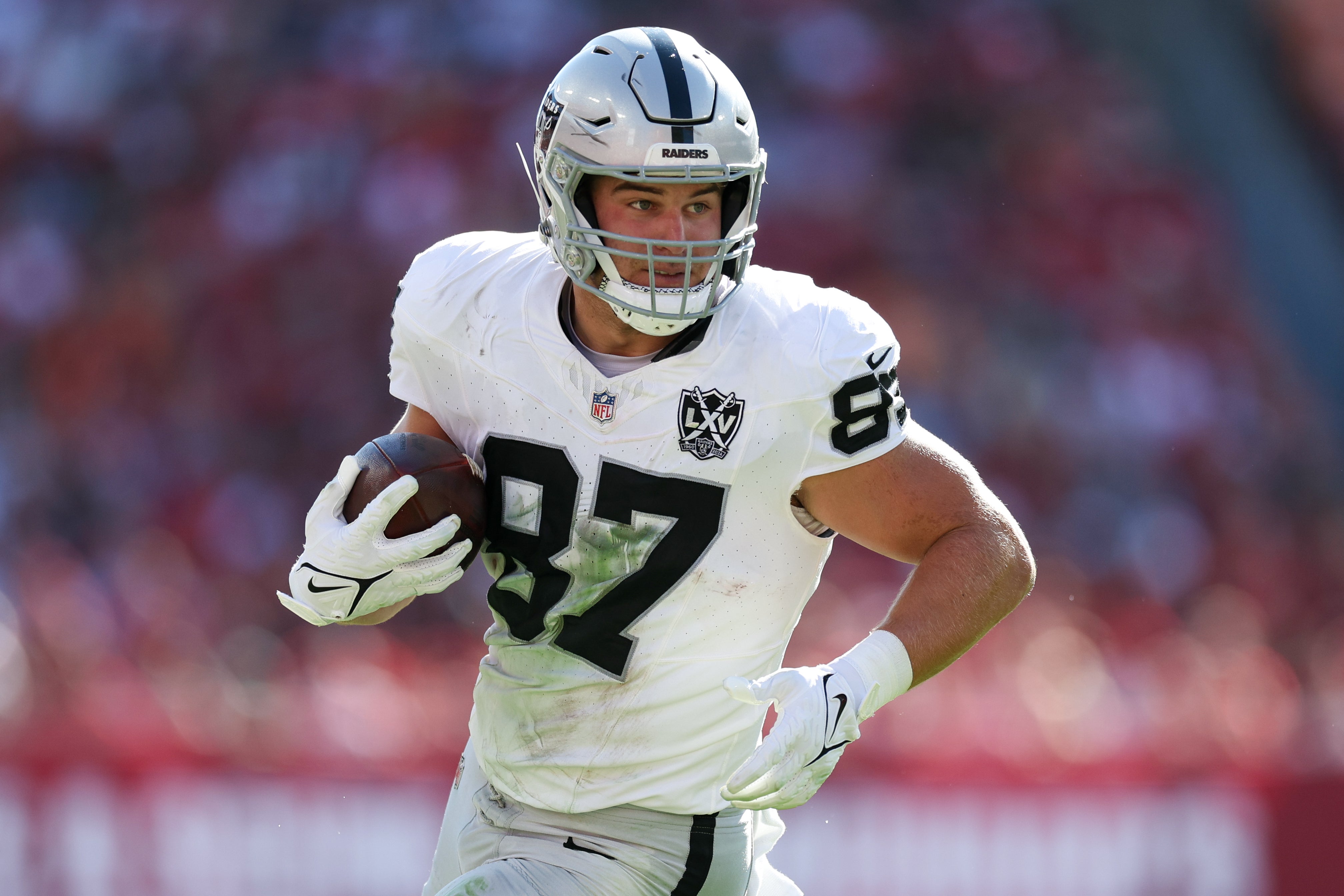 Dec 8, 2024; Tampa, Florida, USA; Las Vegas Raiders tight end Michael Mayer (87) runs with the ball against the Tampa Bay Buccaneers in the second quarter at Raymond James Stadium.