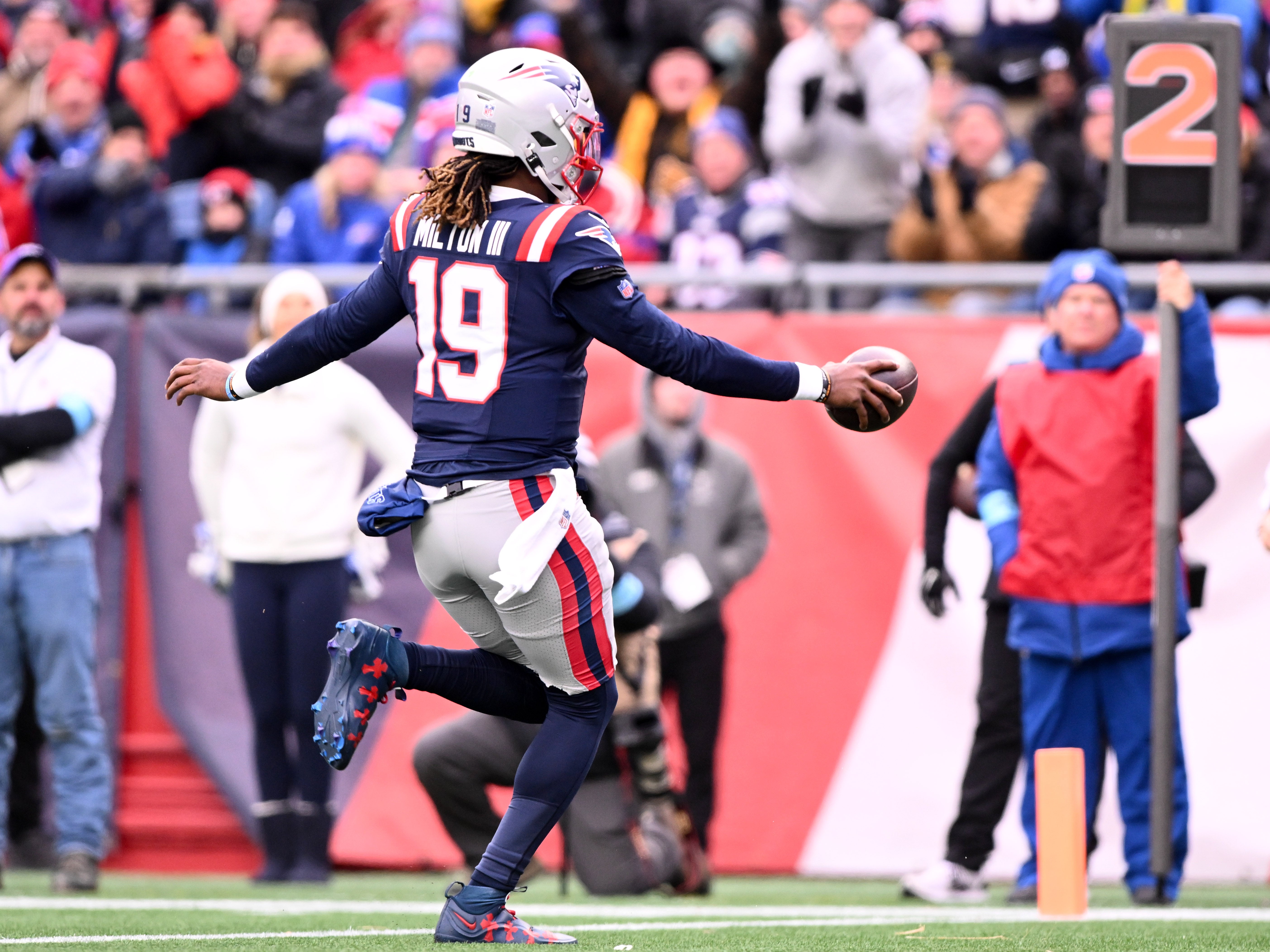 Jan 5, 2025; Foxborough, Massachusetts, USA; New England Patriots quarterback Joe Milton III (19) runs for a touchdown against the Buffalo Bills during the first half at Gillette Stadium.