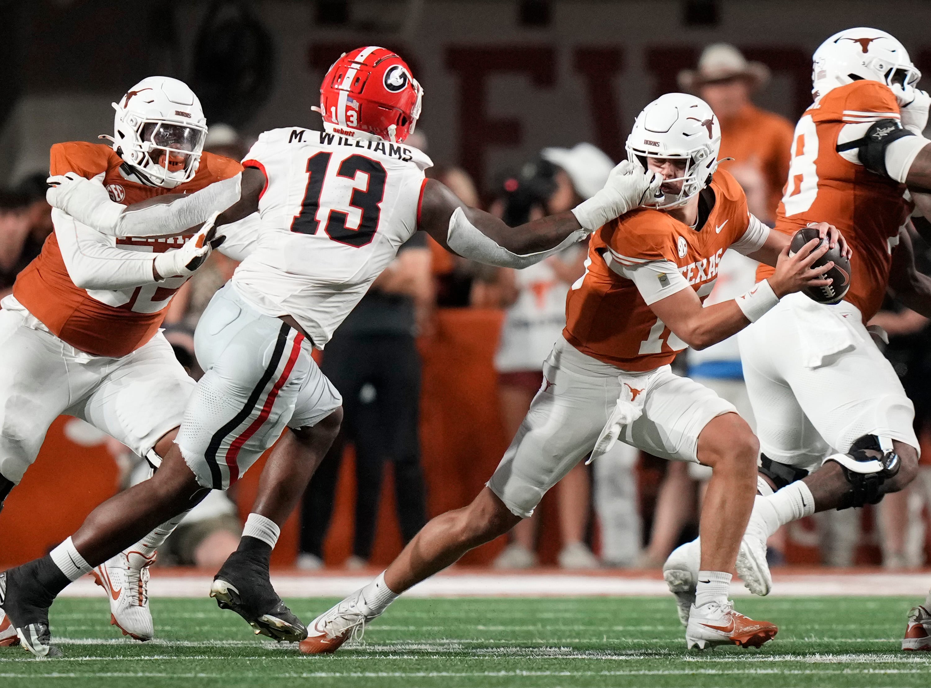 Oct 19, 2024; Austin, Texas, USA; Georgia Bulldogs defensive lineman Mykel Williams face masks Texas Longhorns quarterback Arch Manning in the second quarter at Darrell K. Royal Texas Memorial Stadium.