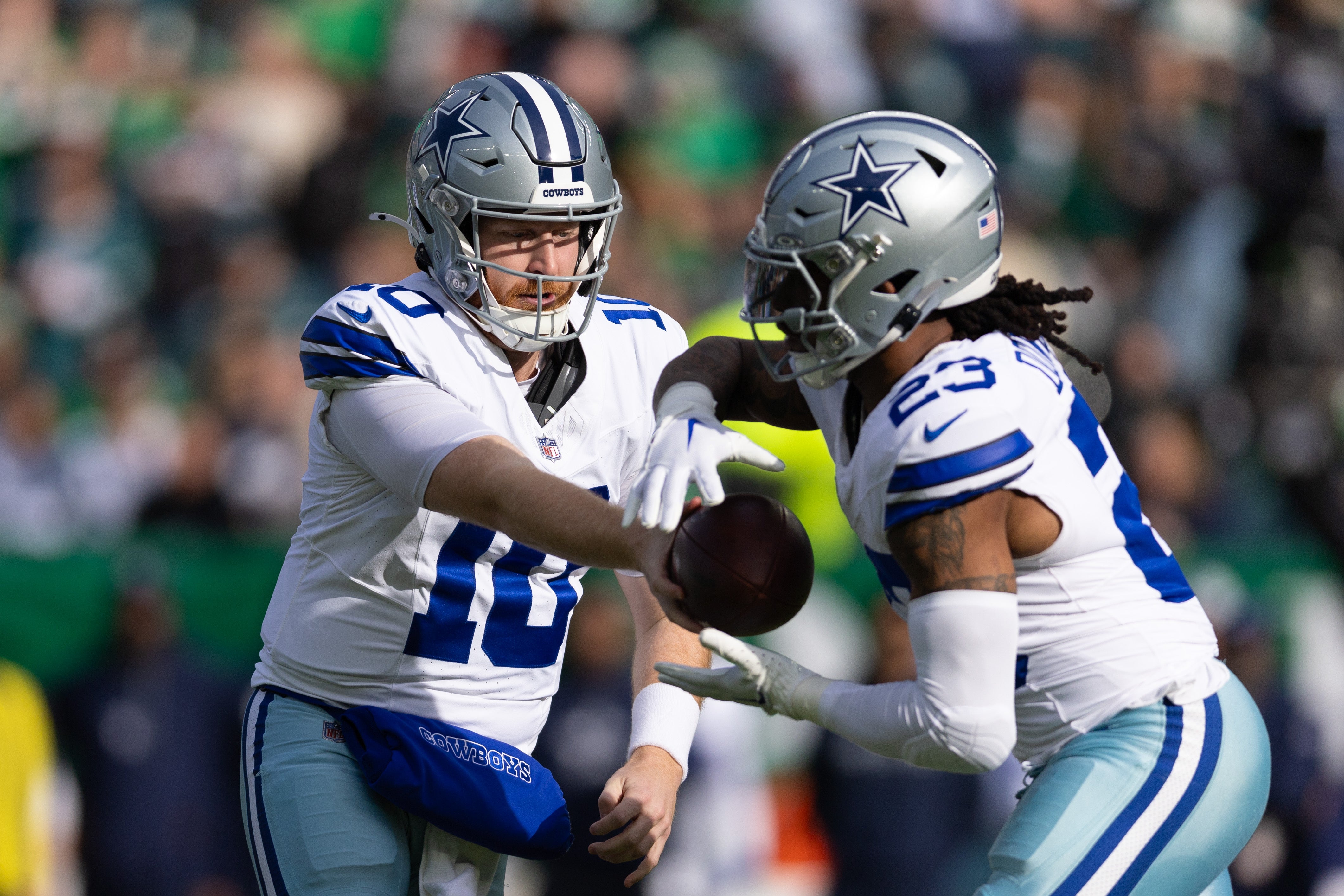 Dallas Cowboys quarterback Cooper Rush (10) hands off to running back Rico Dowdle (23) against the Philadelphia Eagles during the first quarter at Lincoln Financial Field.