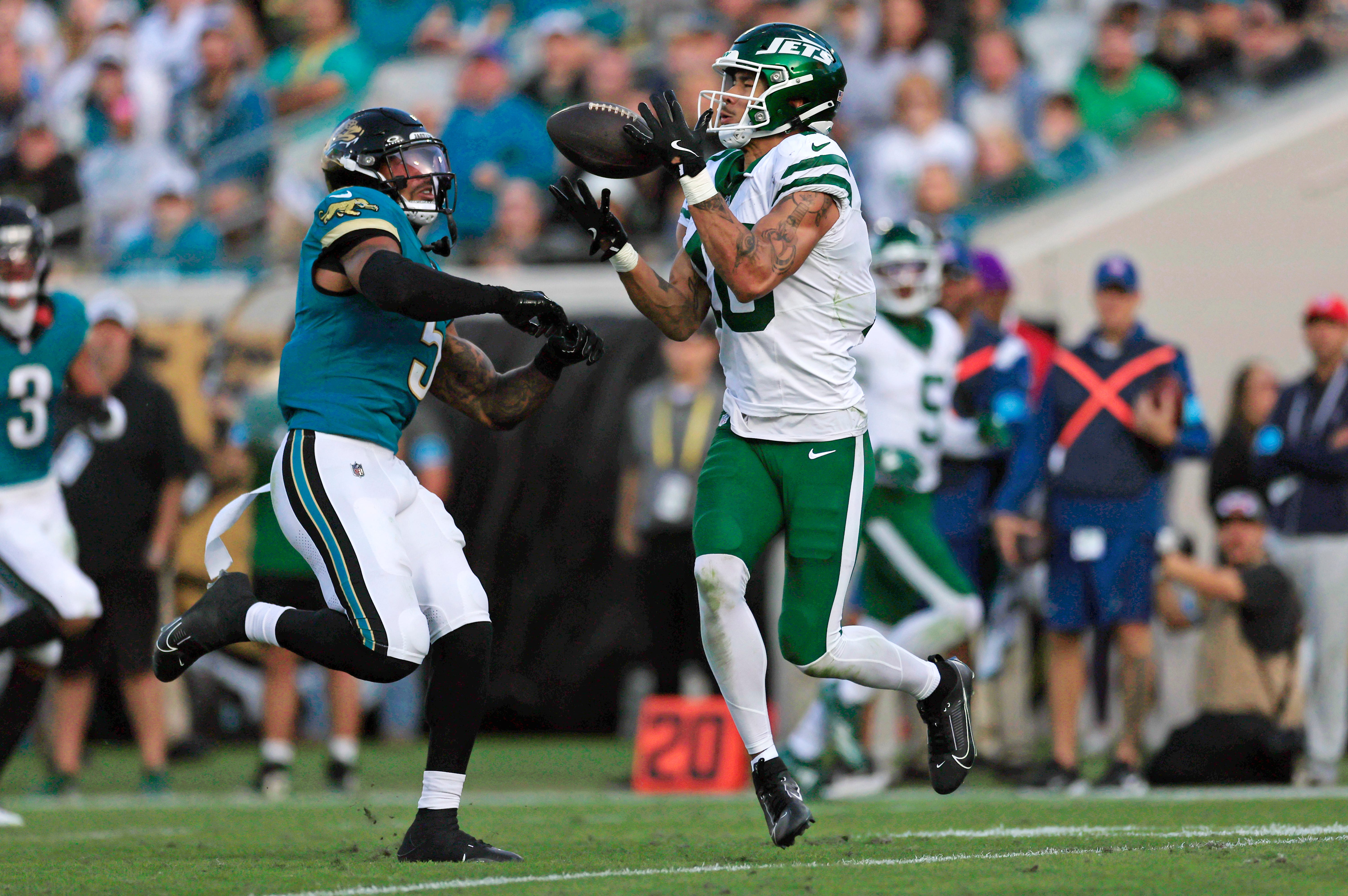 Jacksonville Jaguars safety Andre Cisco (5) breaks up a pass intended for New York Jets wide receiver Allen Lazard (10) during the fourth quarter Sunday, Dec. 15, 2024 at EverBank Stadium in Jacksonville, Fla. The Jets held off the Jaguars 32-25.