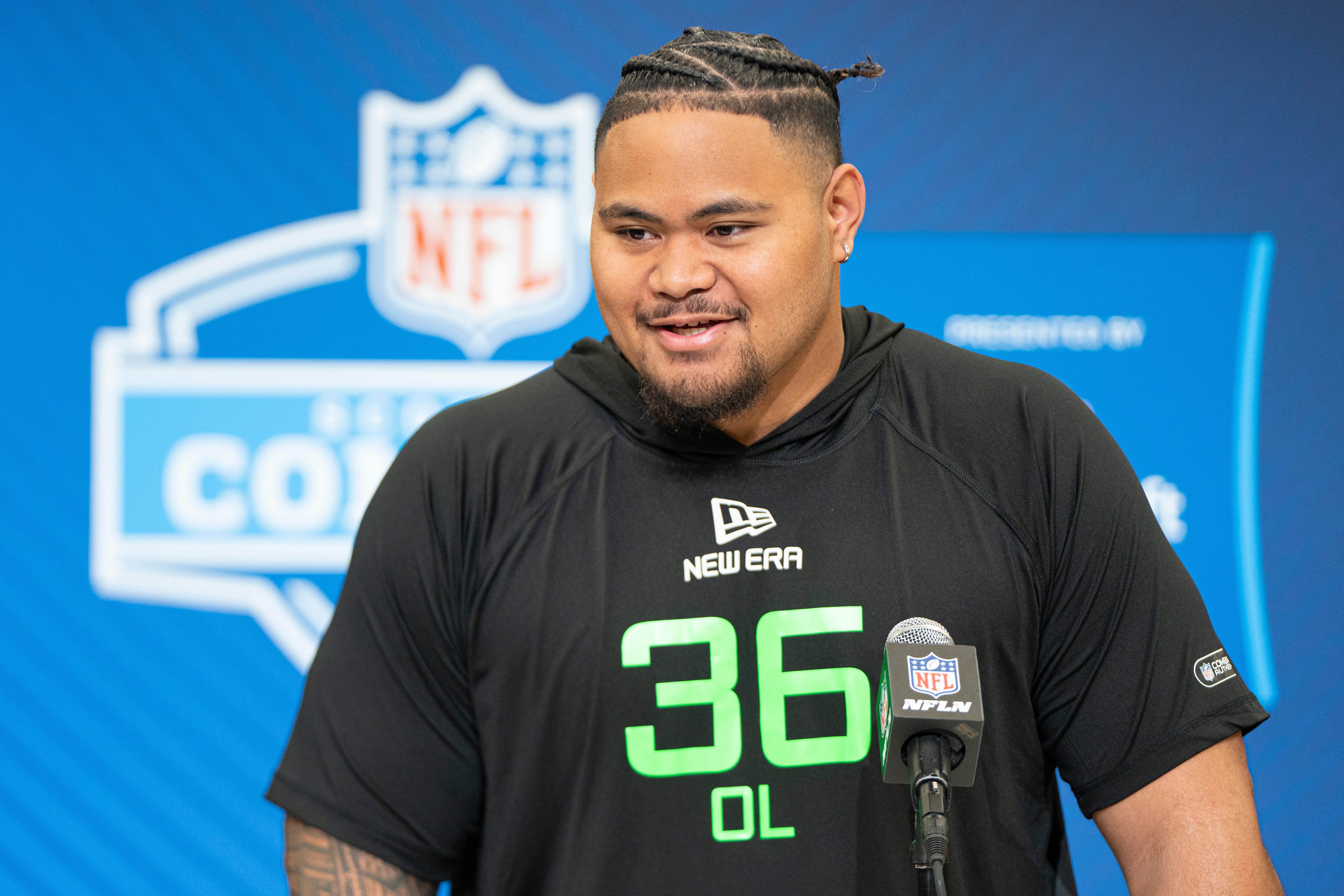 University of Arizona offensive lineman Jonah Savaiinaea (OL36) answers questions at a press conference during the 2025 NFL Combine at Indiana Convention Center.