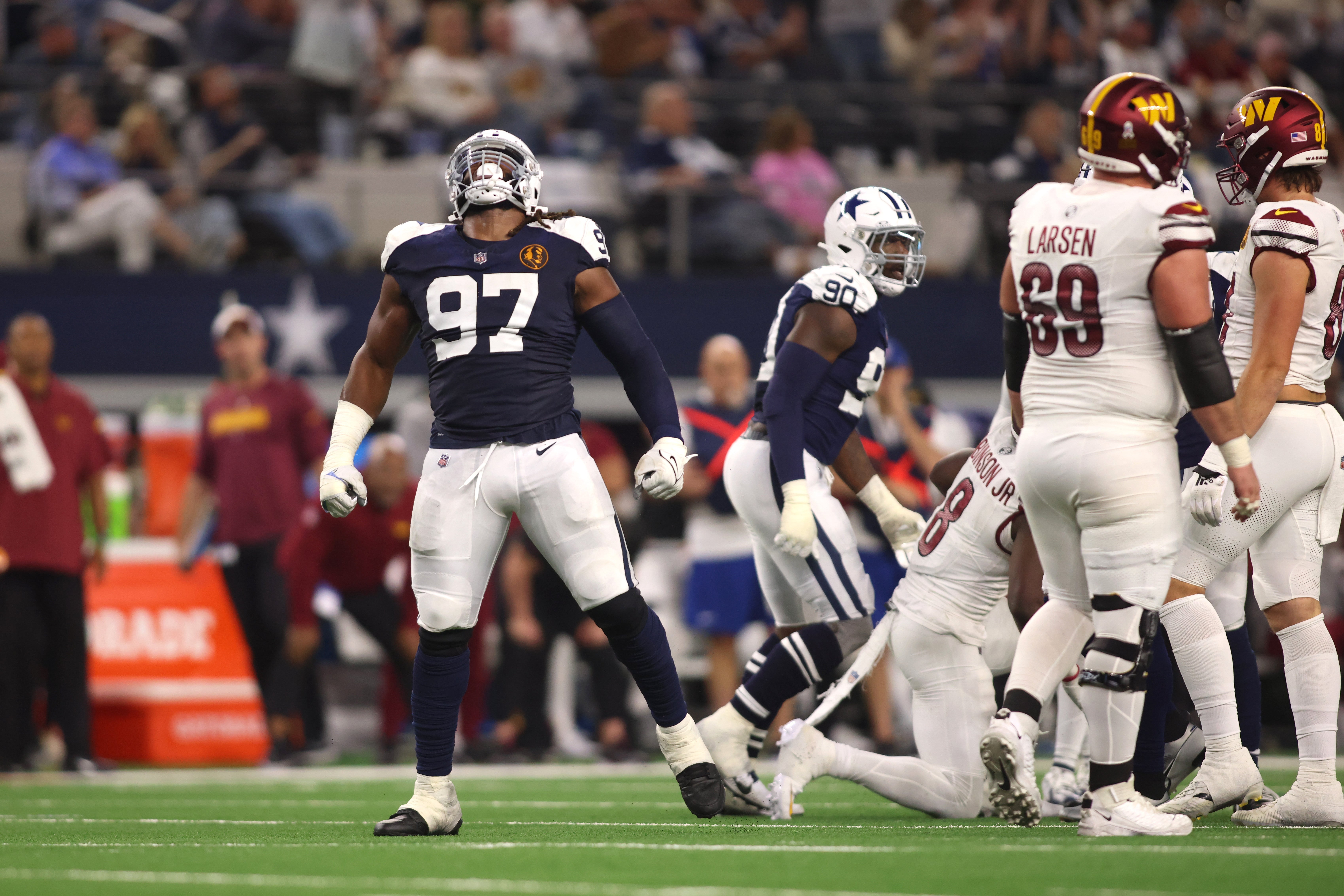 Dallas Cowboys defensive tackle Osa Odighizuwa (97) celebrates a sack in the second half against the Washington Commanders at AT&T Stadium.