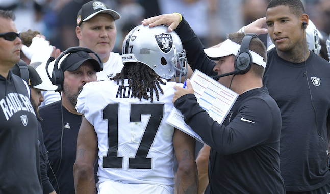 Raiders heads coach Josh McDaniels talks to Las Vegas Raiders wide receiver Davante Adams (17) after his first quarter touchdown catch. The Jacksonville Jaguars hosted the Las Vegas Raiders at TIAA Bank Field in Jacksonville, FL Sunday November 6, 2022. The Jaguars trailed 20 to 10 at the end of the first half.