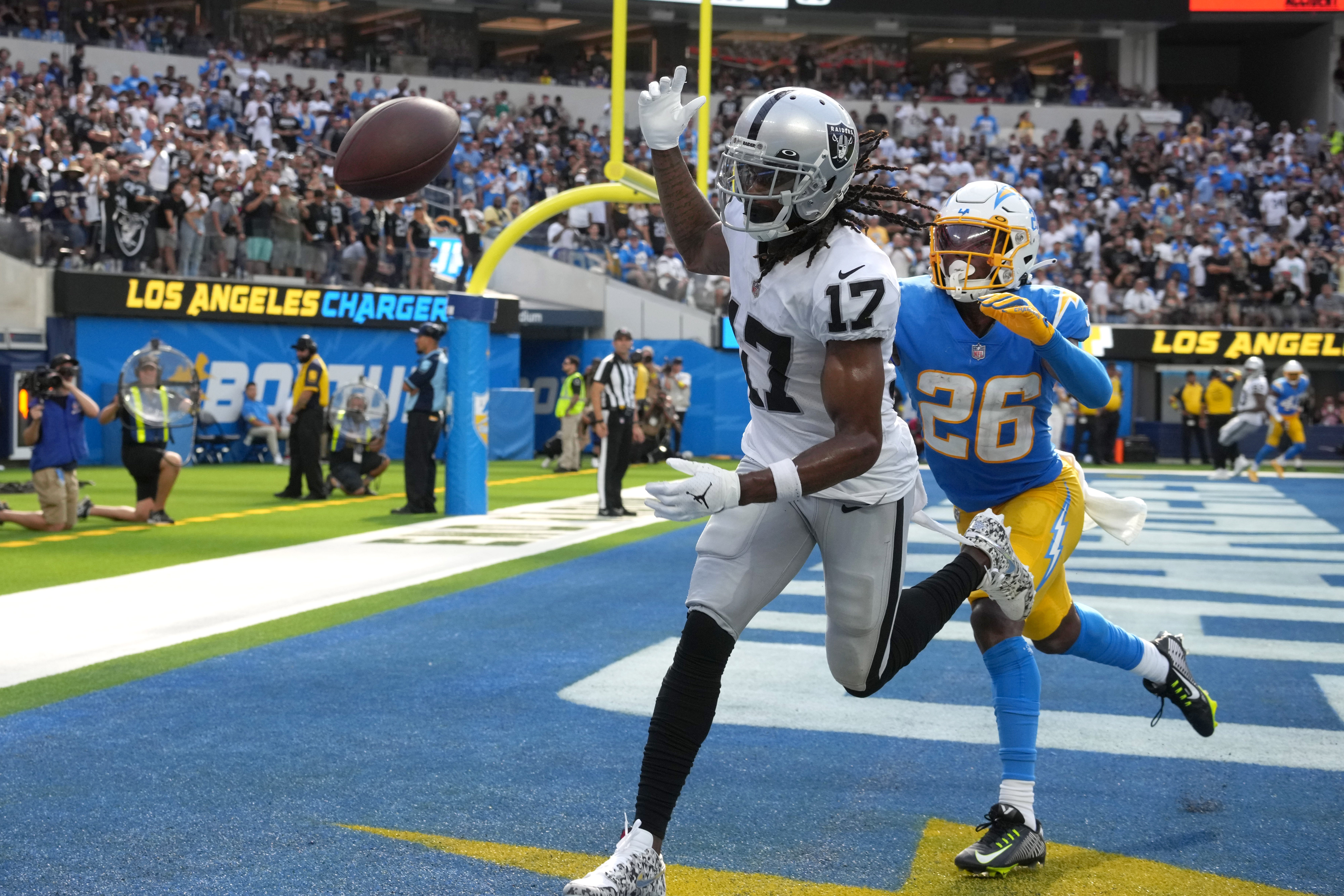 Las Vegas Raiders wide receiver Davante Adams (17) reaches for a pass against Los Angeles Chargers cornerback Asante Samuel Jr. (26) in the second half at SoFi Stadium.