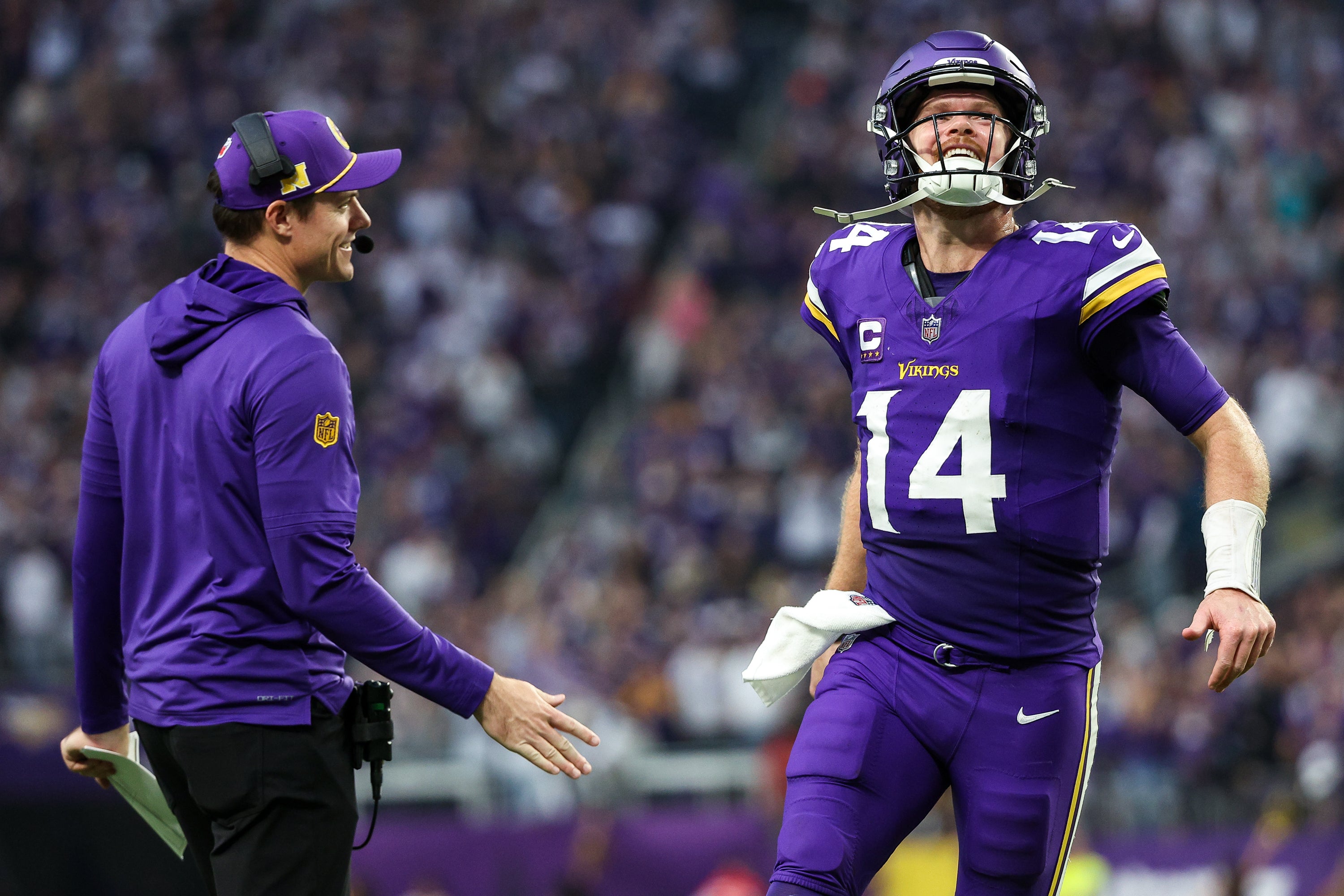 Dec 8, 2024; Minneapolis, Minnesota, USA; Minnesota Vikings quarterback Sam Darnold (14) celebrates running back Aaron Jones' (33) touchdown run with head coach Kevin O'Connell during the fourth quarter against the Atlanta Falcons at U.S. Bank Stadium.
