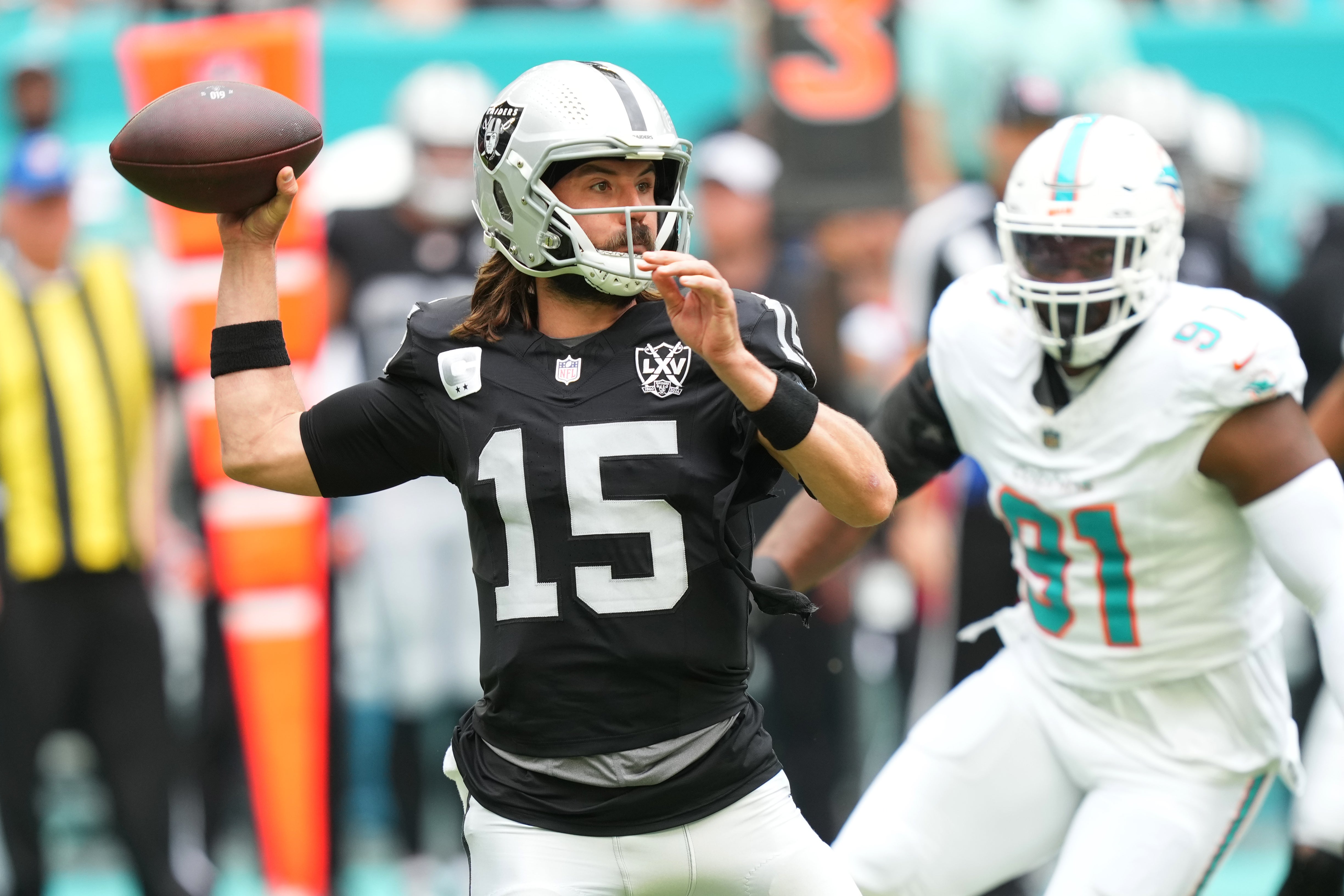 Nov 17, 2024; Miami Gardens, Florida, USA; Las Vegas Raiders quarterback Gardner Minshew (15) drops back to pass against the Miami Dolphins in the first quarter at Hard Rock Stadium.
