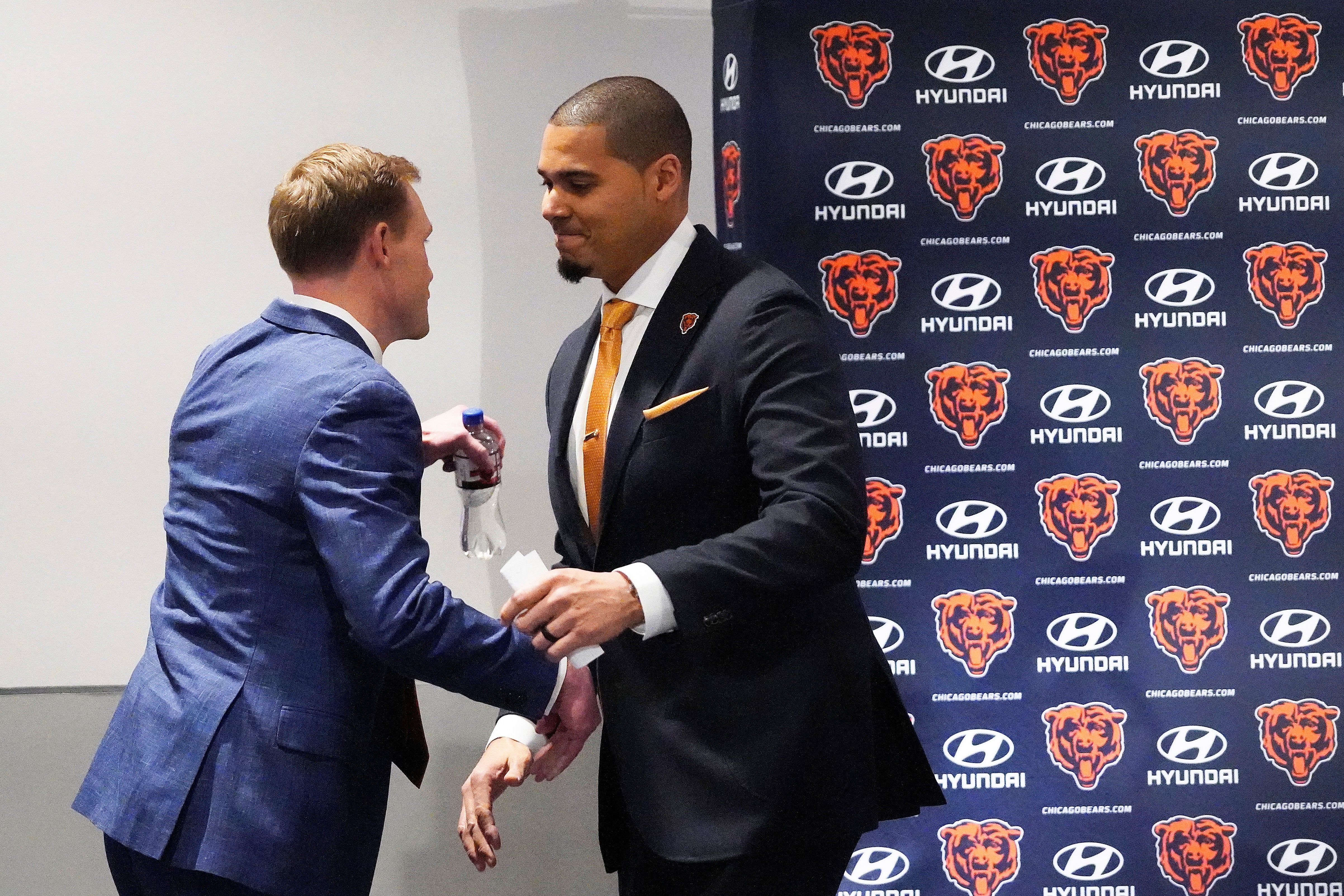 Jan 22, 2025; Lake Forest, IL, USA; Chicago Bears new head coach Ben Johnson is greeted by general manager Ryan Poles at his introductory press conference at PNC Center.