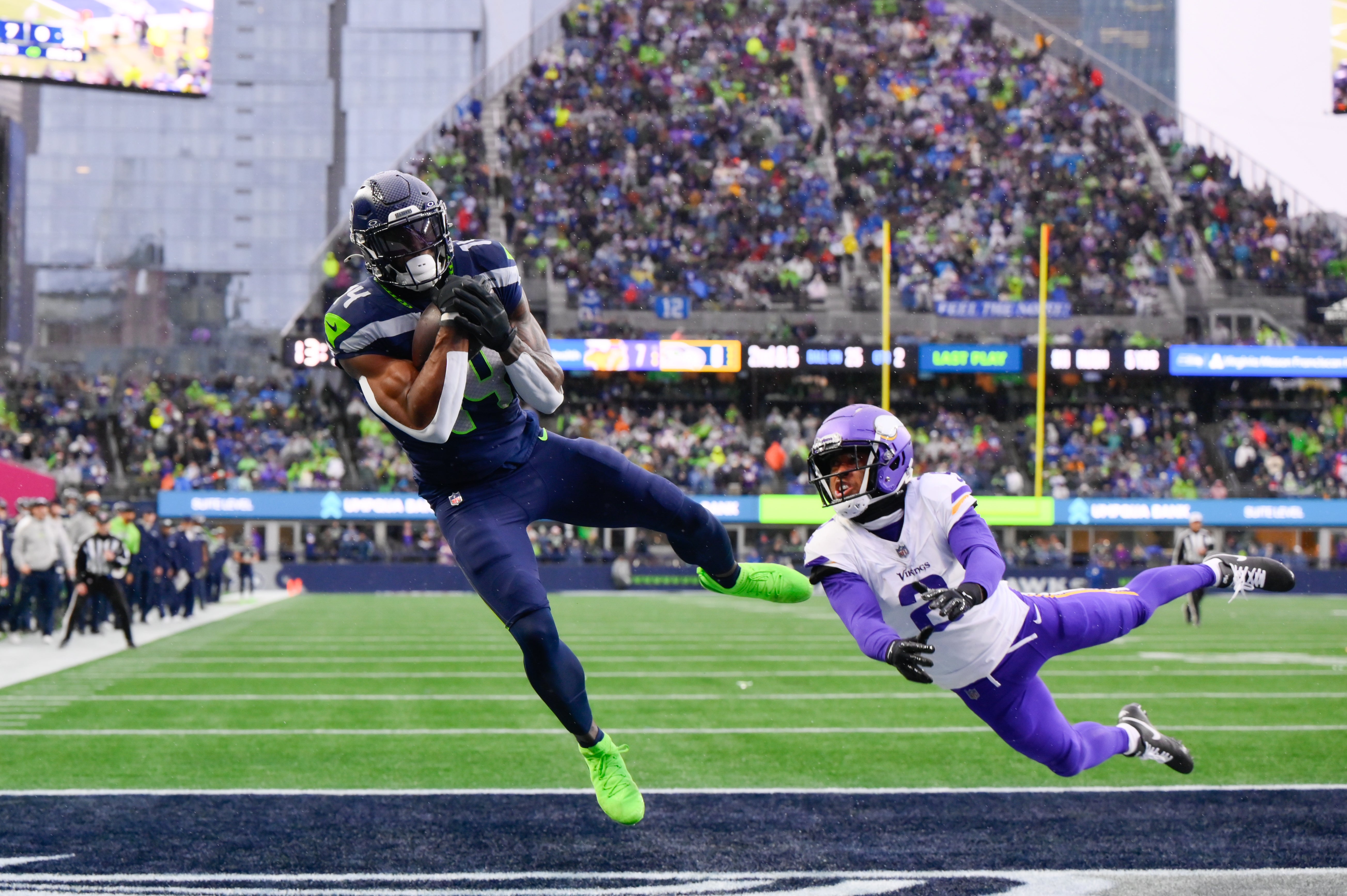 Seattle Seahawks wide receiver DK Metcalf (14) catches a pass for a touchdown while defended by Minnesota Vikings cornerback Stephon Gilmore (2) during the first half at Lumen Field.