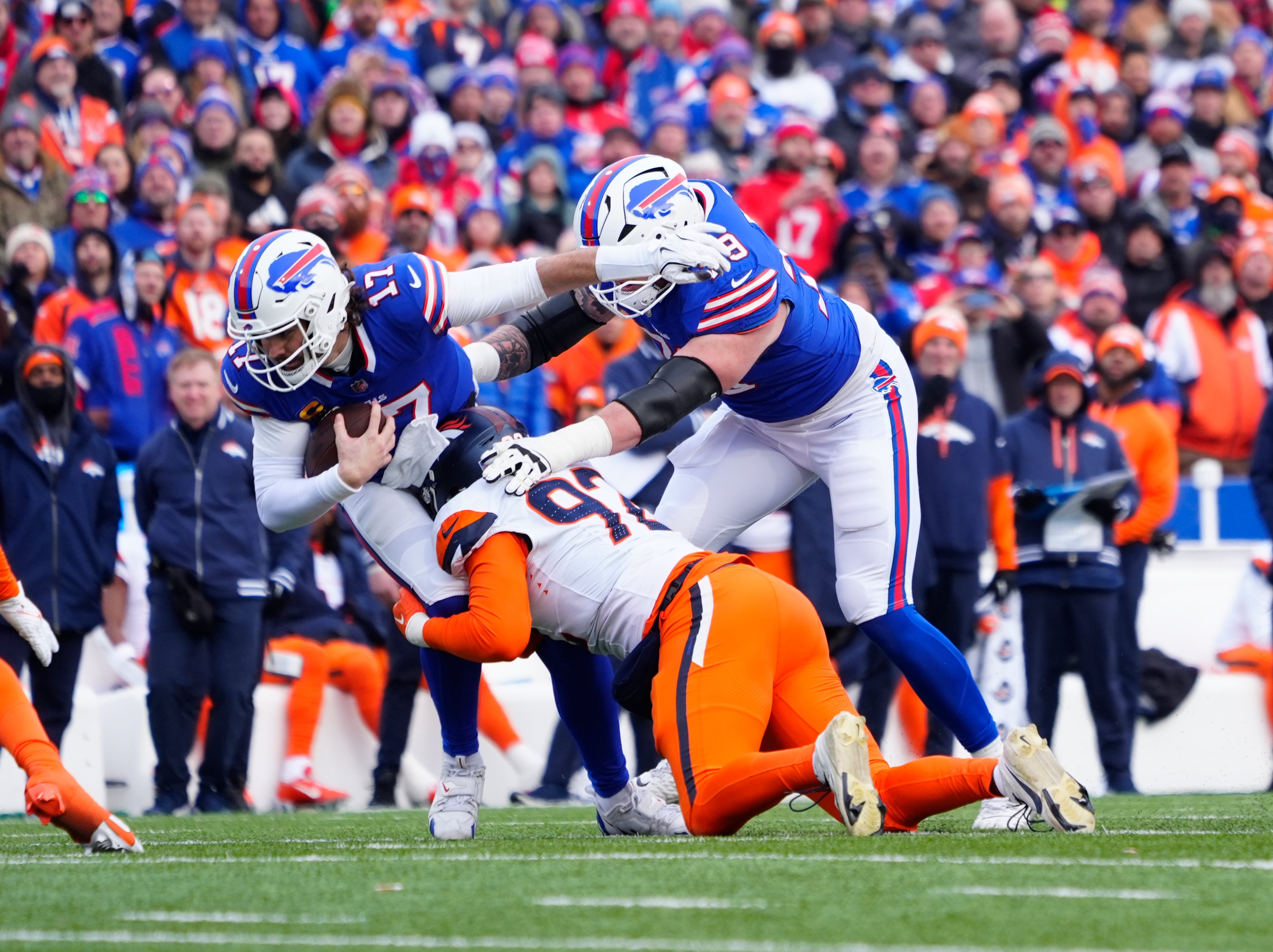 Bills quarterback Josh Allen (17) is sacked by Broncos linebacker Dondrea Tillman (92)