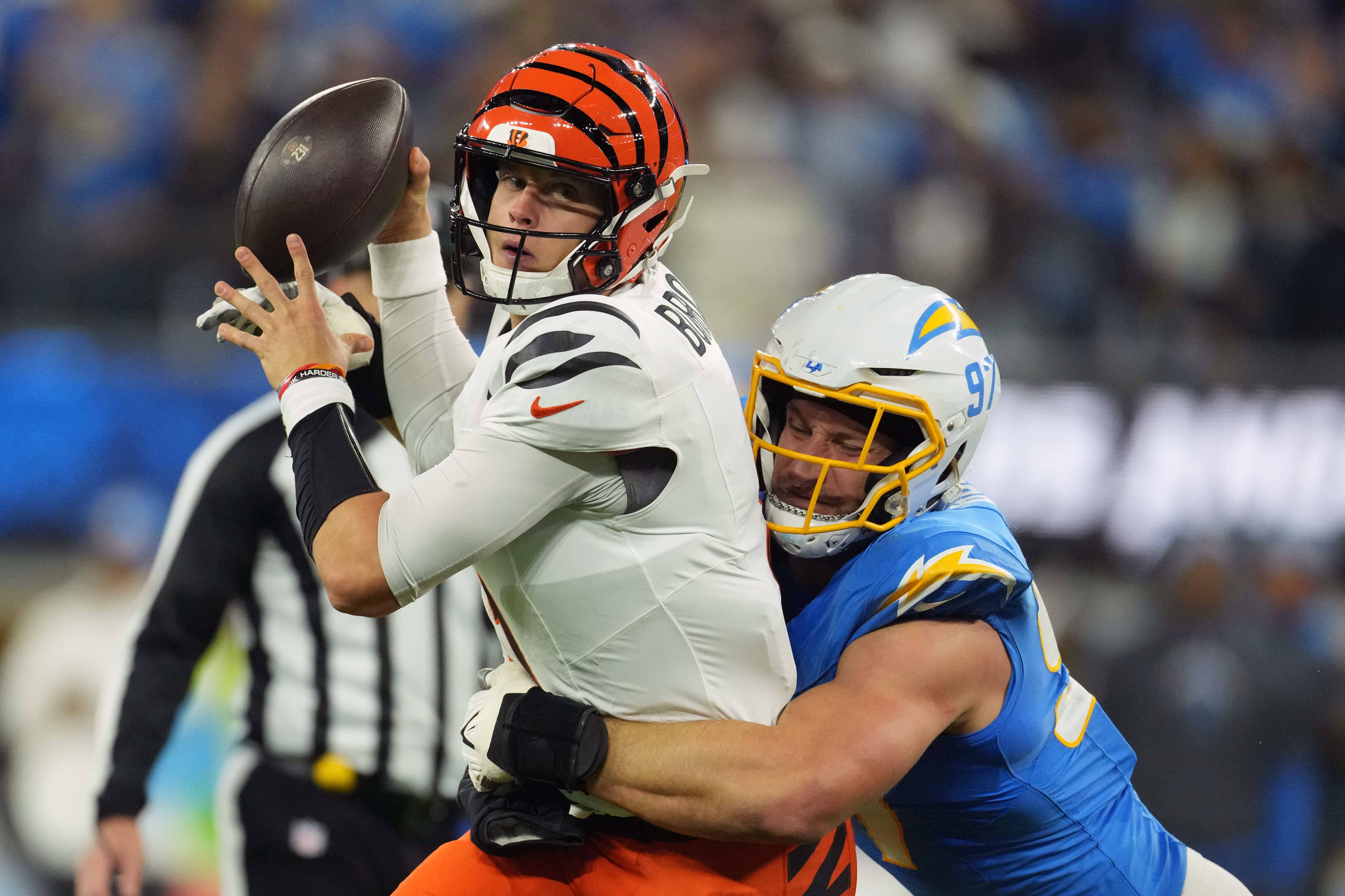 Nov 17, 2024; Inglewood, California, USA; Cincinnati Bengals quarterback Joe Burrow (9) is pressured by Los Angeles Chargers linebacker Joey Bosa (97) in the first half at SoFi Stadium.