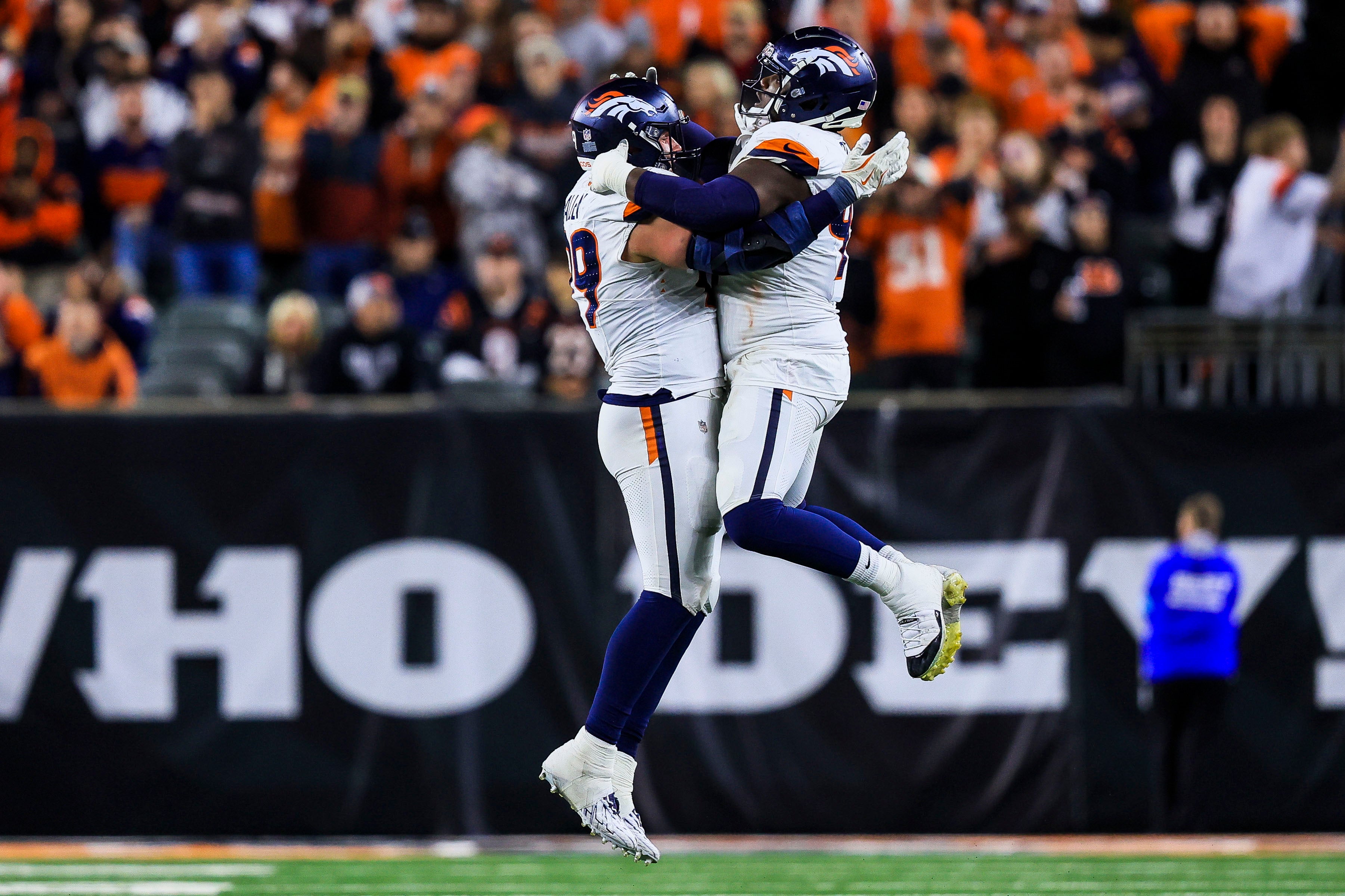 Broncos defensive end Zach Allen (99) celebrates after a play with defensive tackle Malcolm Roach (97) in overtime against the Bengals.