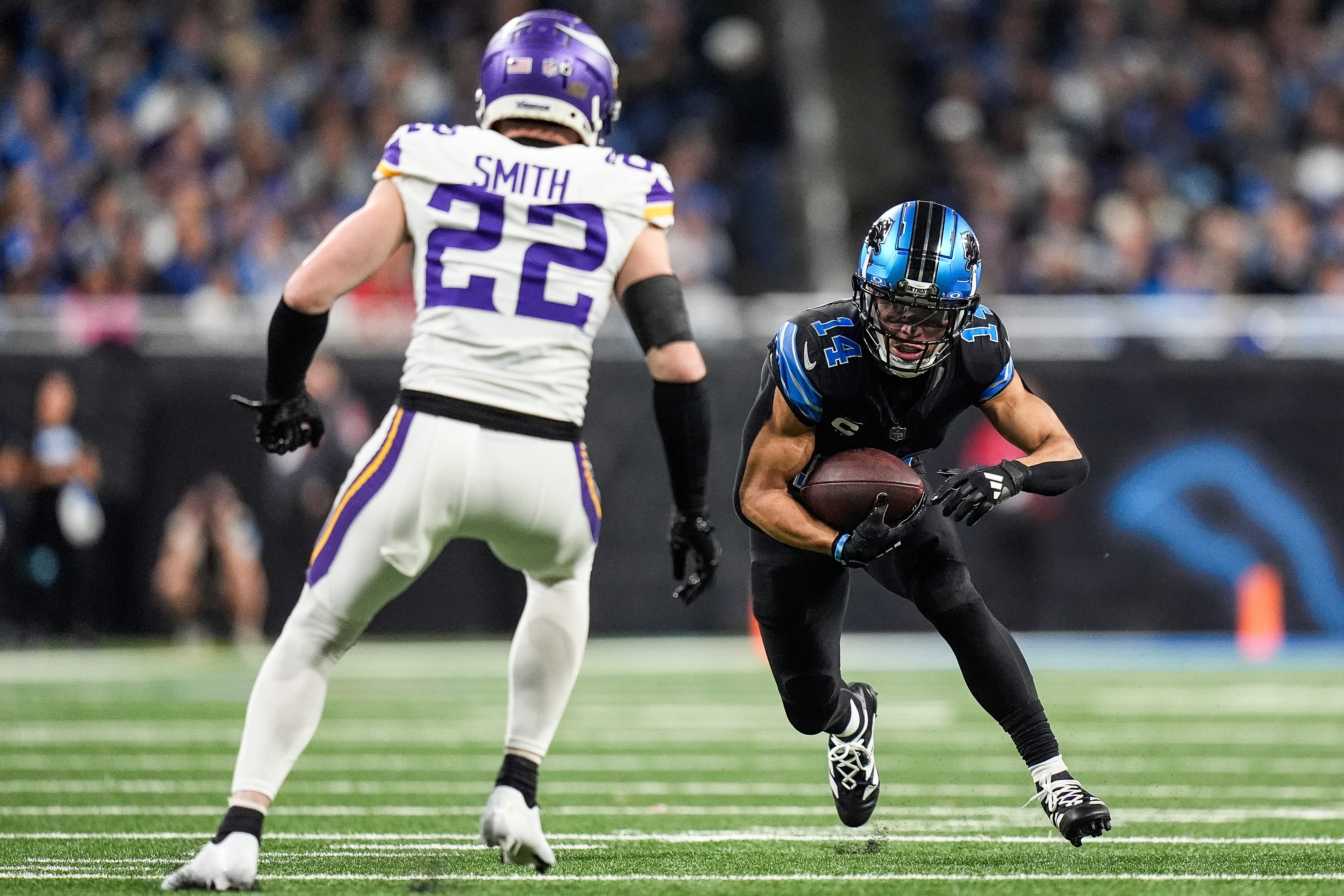 Detroit Lions wide receiver Amon-Ra St. Brown (14) runs against Minnesota Vikings safety Harrison Smith (22) during the second half at Ford Field in Detroit on Sunday, Jan. 5, 2025.