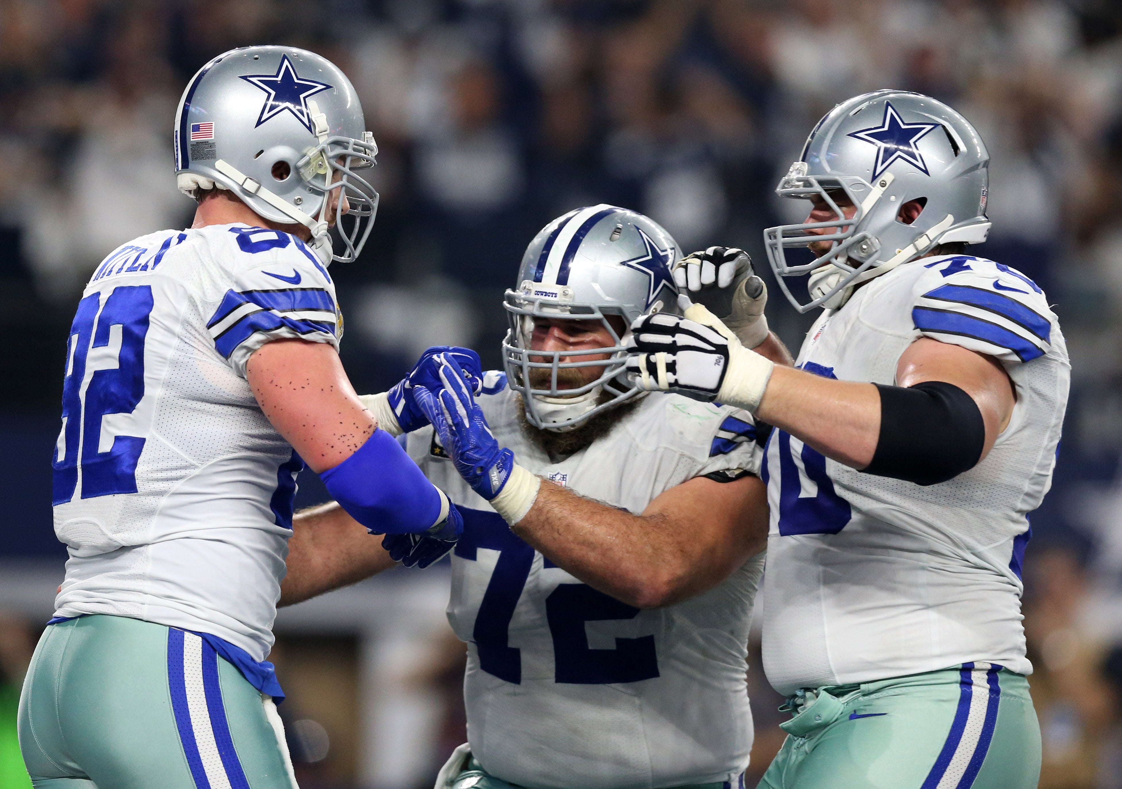 Dallas Cowboys tight end Jason Witten (82) celebrates his touchdown with center Travis Frederick (72) and guard Zack Martin (70) during the fourth quarter against the Green Bay Packers in the NFC Divisional playoff game at AT&T Stadium.