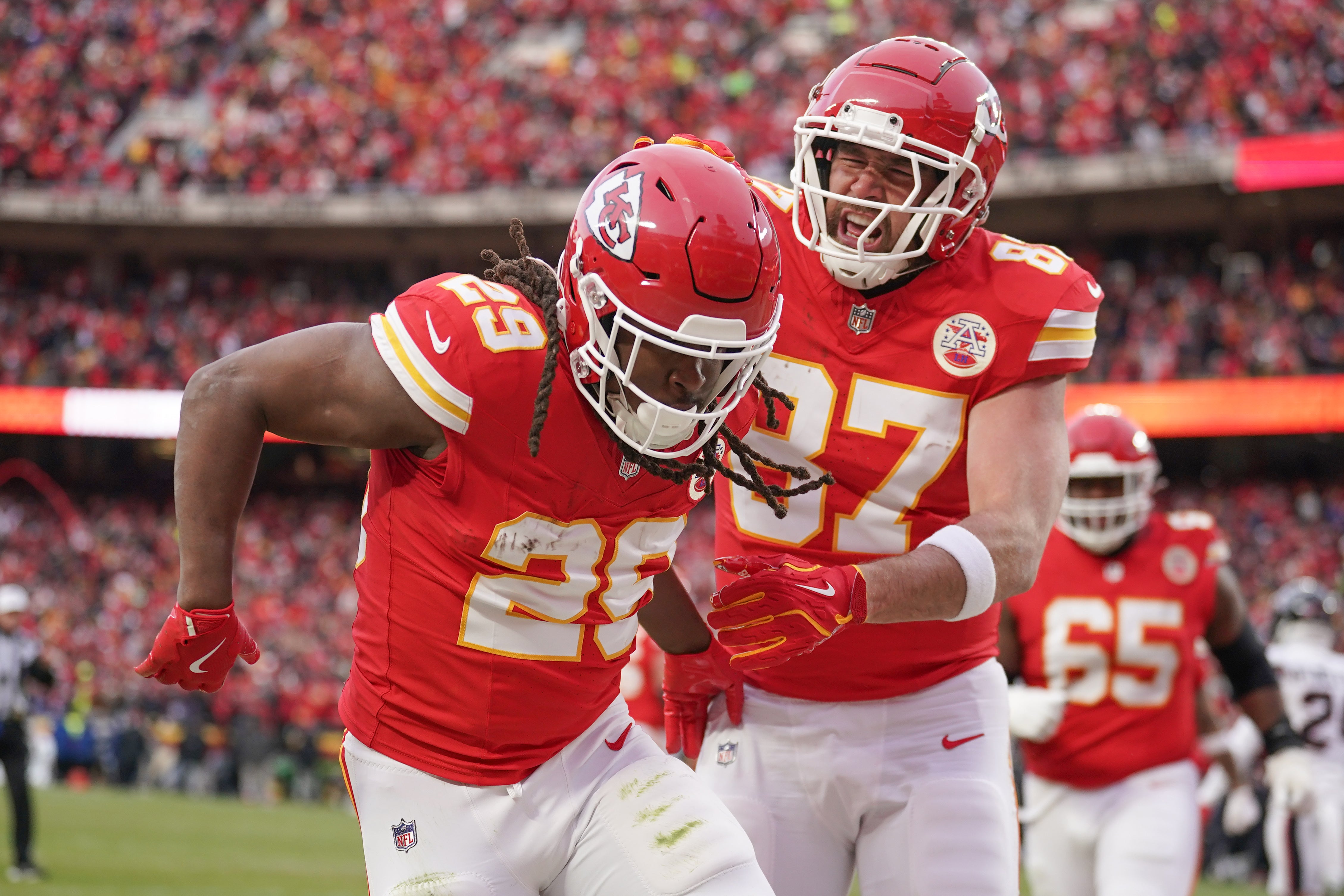 Jan 18, 2025; Kansas City, Missouri, USA; Kansas City Chiefs running back Kareem Hunt (29) celebrates with tight end Travis Kelce (87) after scoring a touchdown against the Houston Texans during the first half of a 2025 AFC divisional round game at GEHA Field at Arrowhead Stadium.