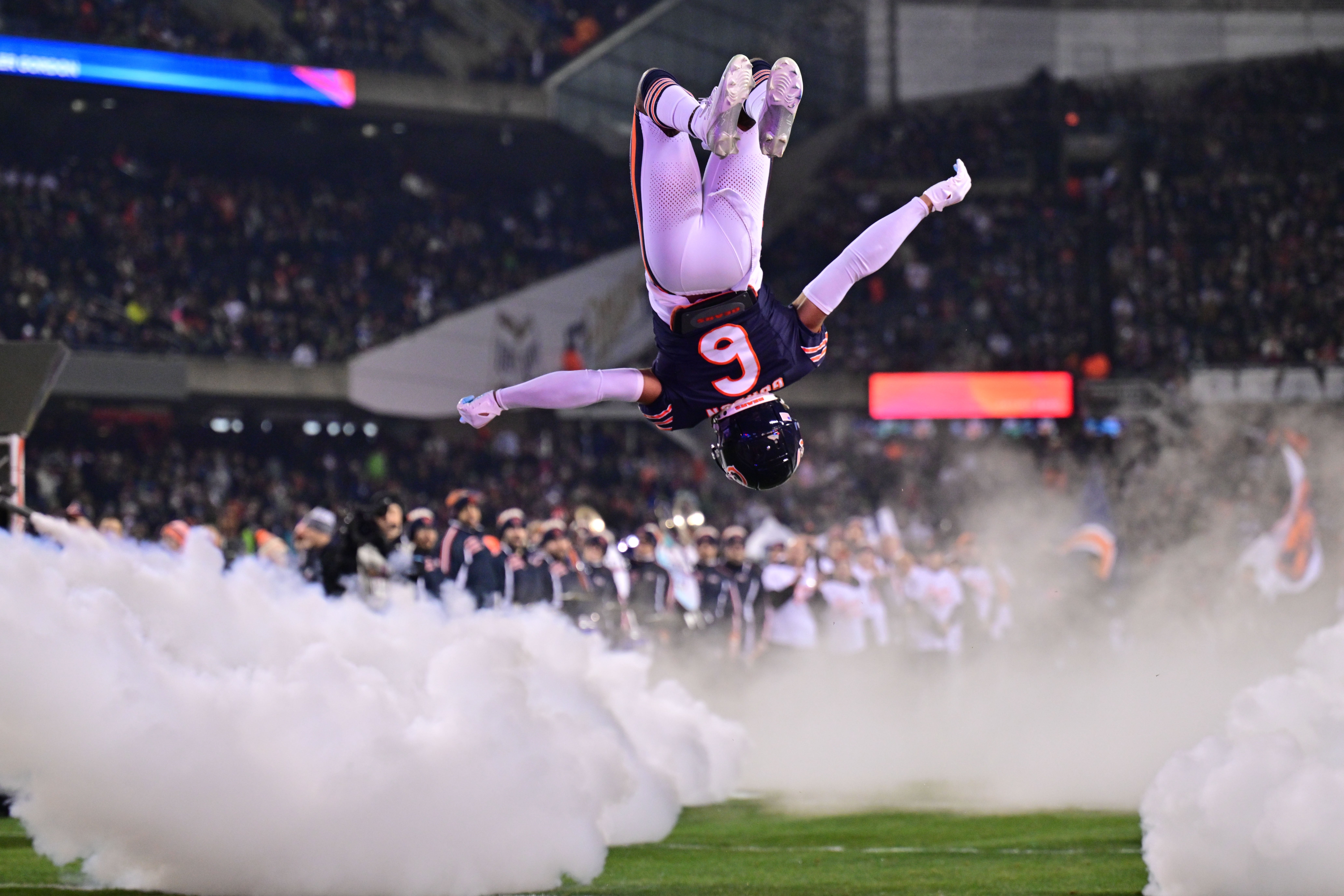 Dec 26, 2024; Chicago, Illinois, USA; Chicago Bears cornerback Kyler Gordon (6) does a back flip as he enters the field before the game against the Seattle Seahawks at Soldier Field.