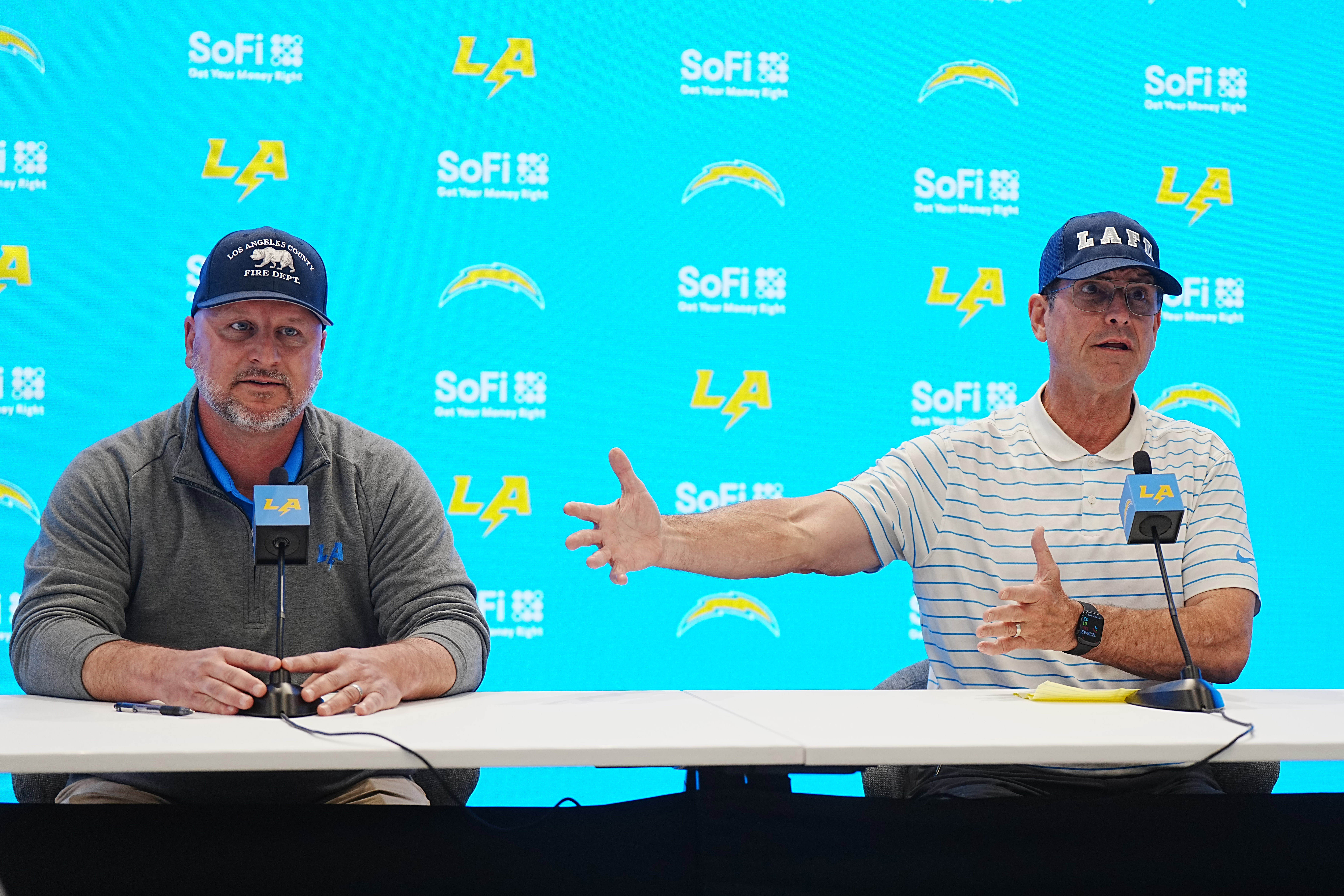 Chargers general manager Joe Hortiz (left) and coach Jim Harbaugh