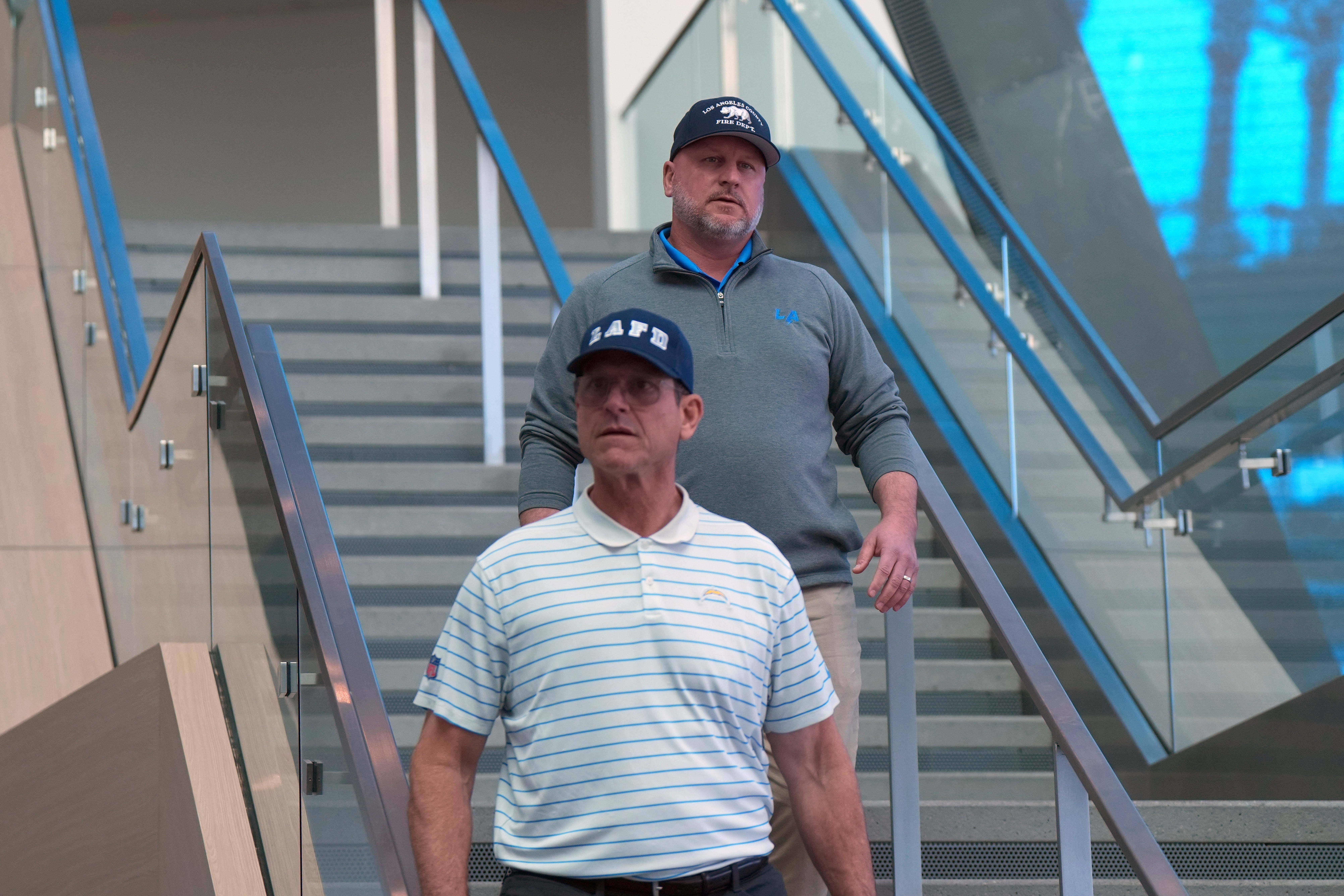 Chargers coach Jim Harbaugh (front) and general manager Joe Hortiz