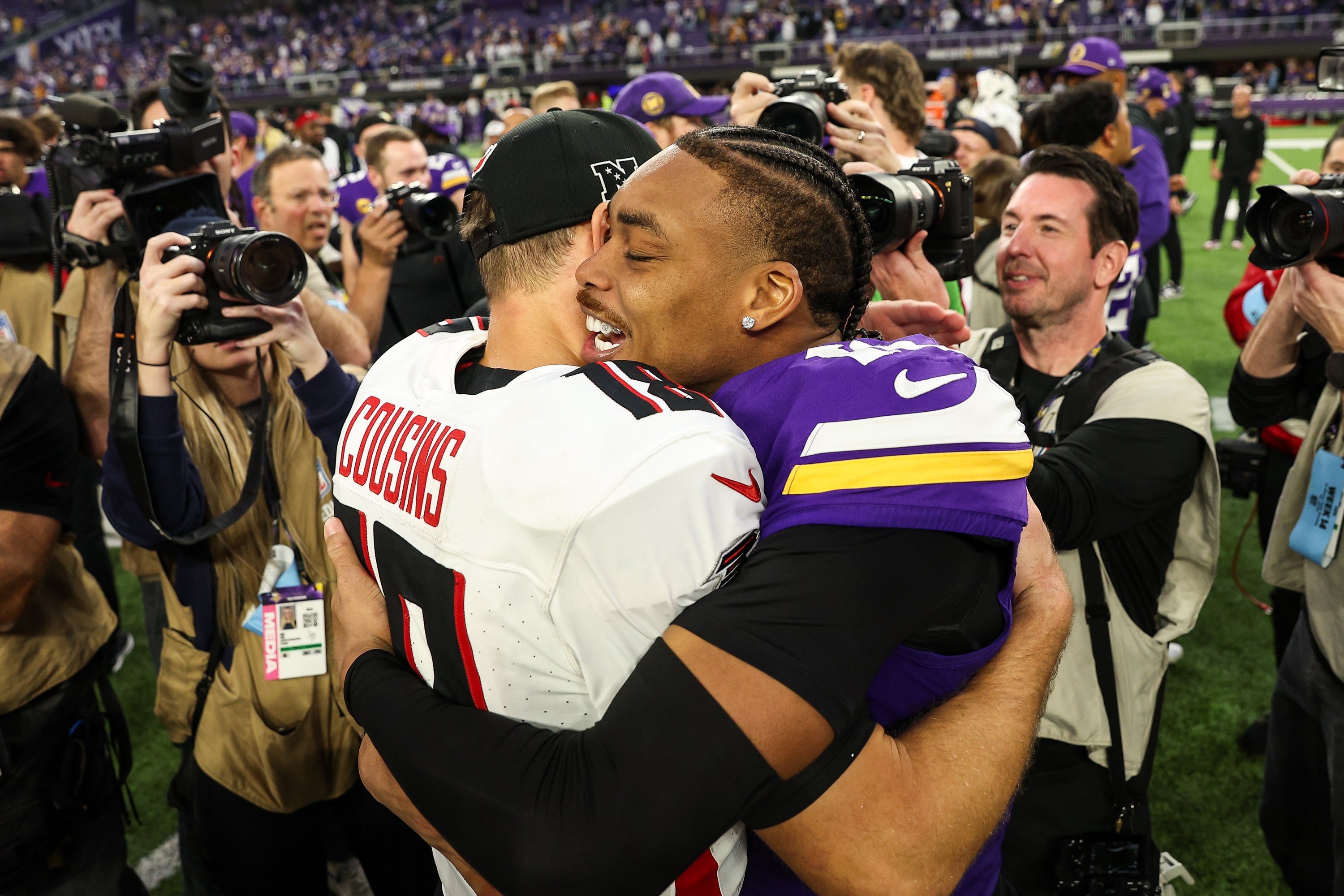 Dec 8, 2024; Minneapolis, Minnesota, USA; Atlanta Falcons quarterback Kirk Cousins (18) and Minnesota Vikings wide receiver Justin Jefferson (18) hug after the game at U.S. Bank Stadium.