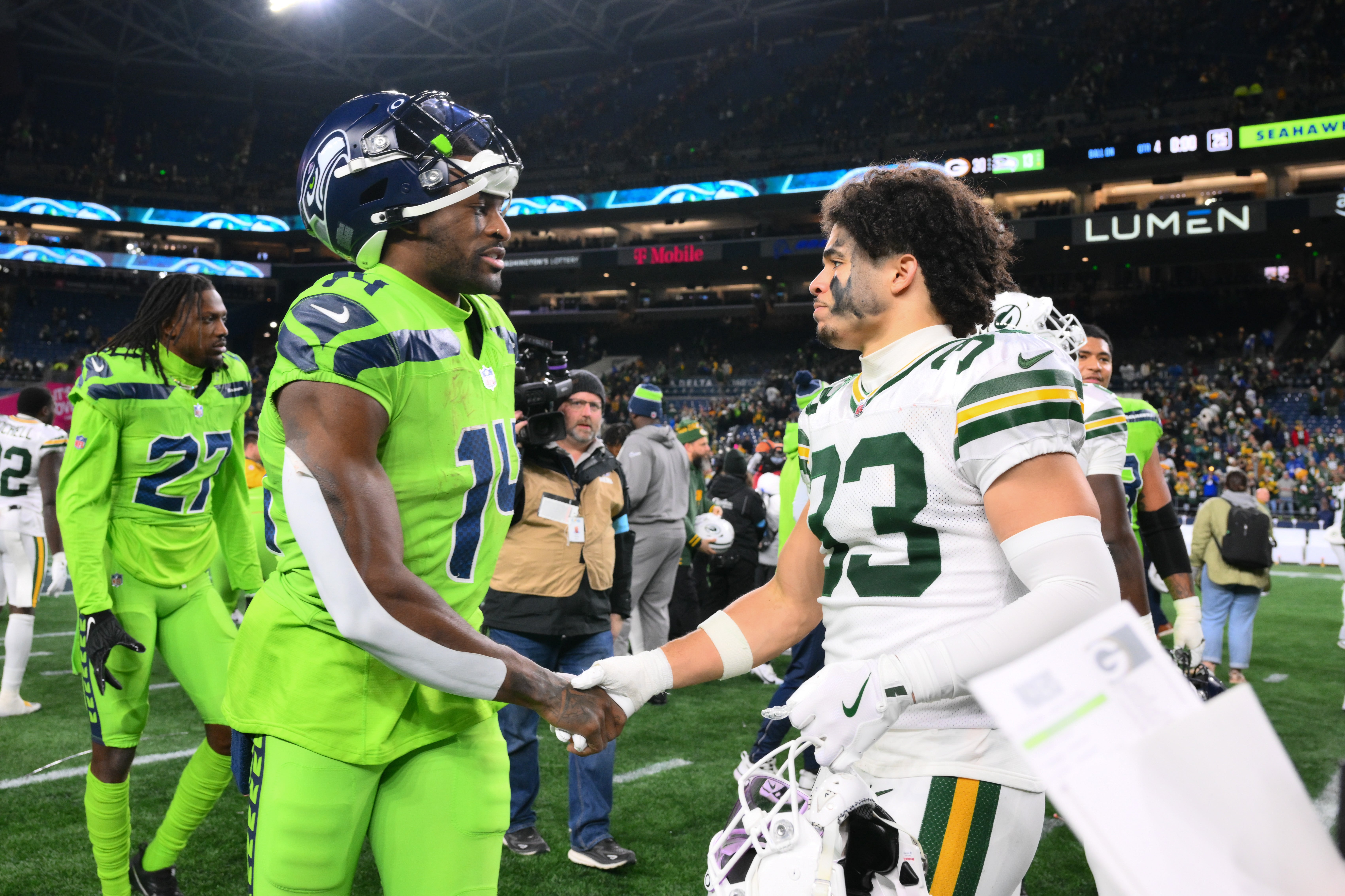 Seattle Seahawks wide receiver DK Metcalf (14) and Green Bay Packers safety Evan Williams (33) shake hands after the game at Lumen Field.