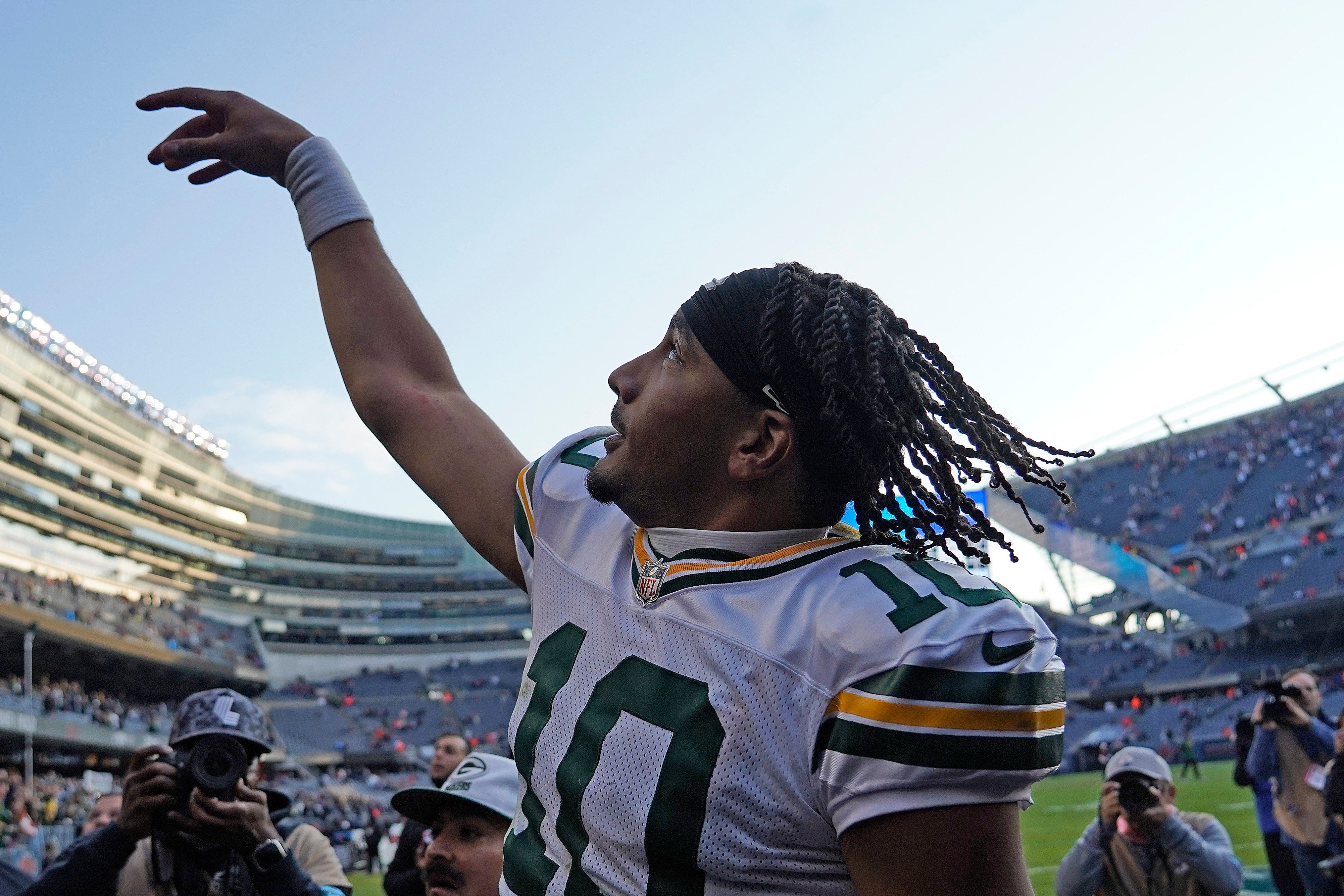 Green Packers Jordan Love gestures as he walks off the field after the win against the Chicago Bears at Soldier Field. 