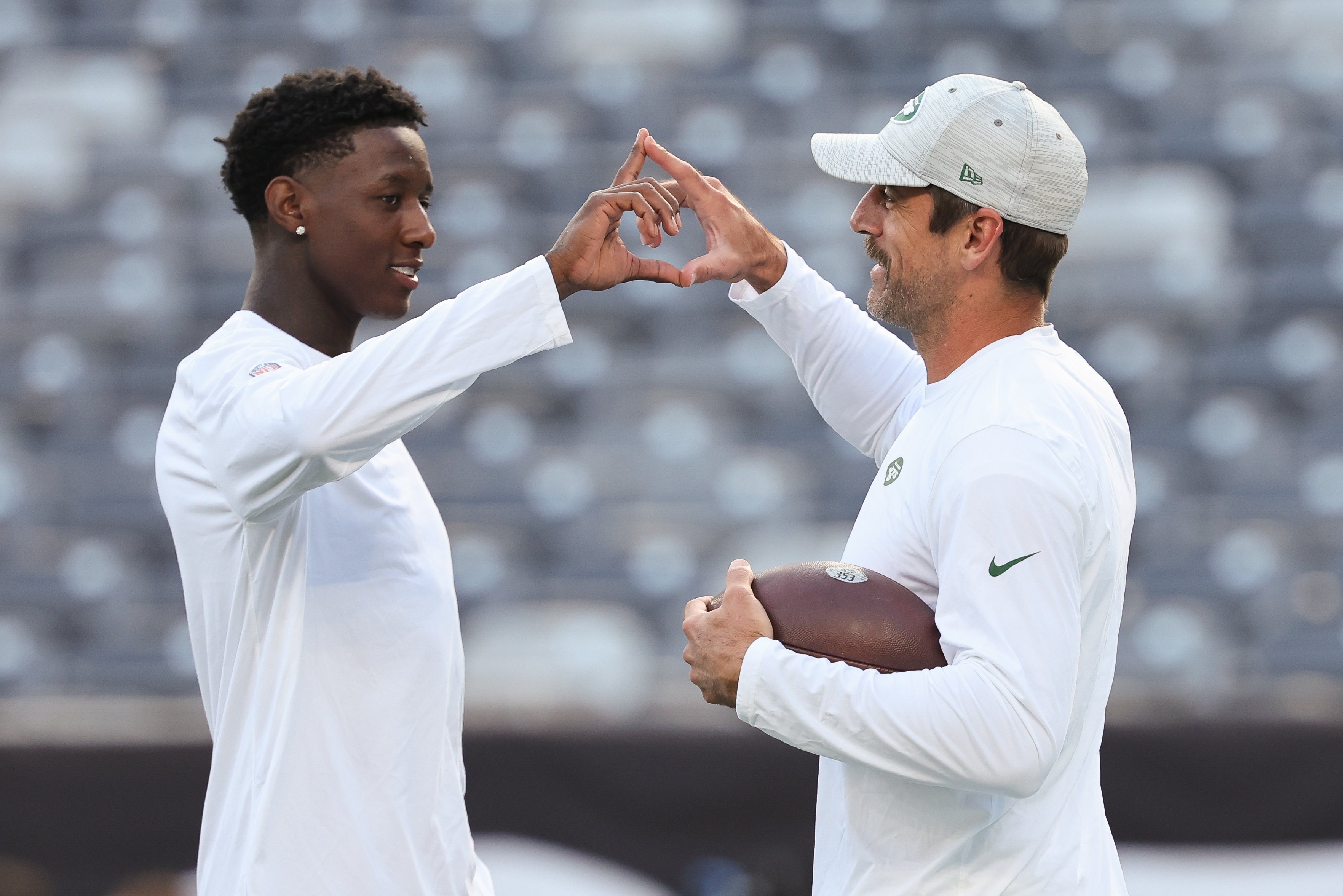 Aug 19, 2023; East Rutherford, New Jersey, USA; New York Jets cornerback Sauce Gardner (left) and quarterback Aaron Rodgers (right ) on the field before the game against the Tampa Bay Buccaneers at MetLife Stadium.
