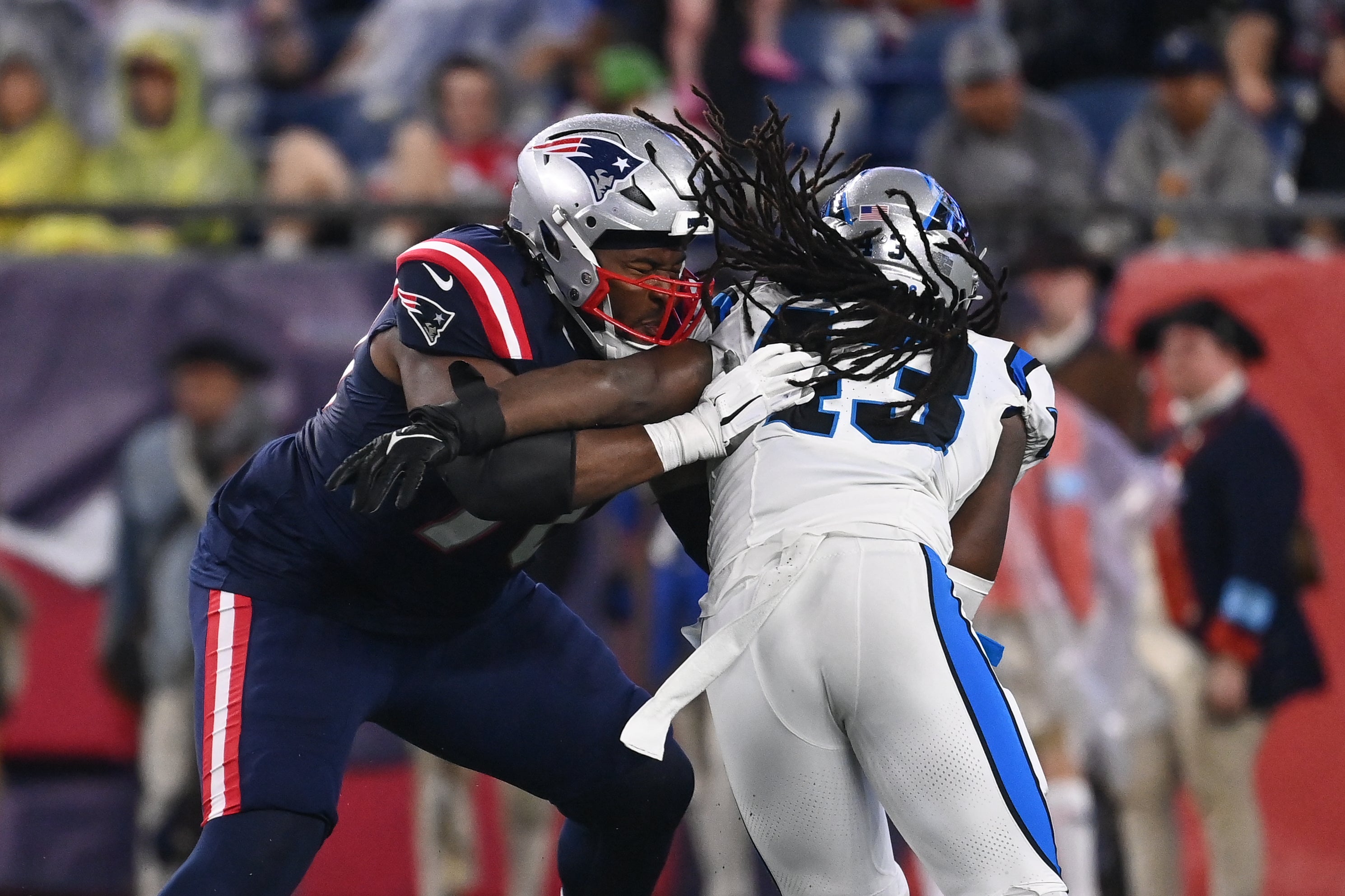 August 8, 2024; Foxborough, MA, USA; New England Patriots offensive tackle Caedan Wallace (70) blocking Carolina Panthers linebacker Luiji Vilain (43) during the first half at Gillette Stadium.