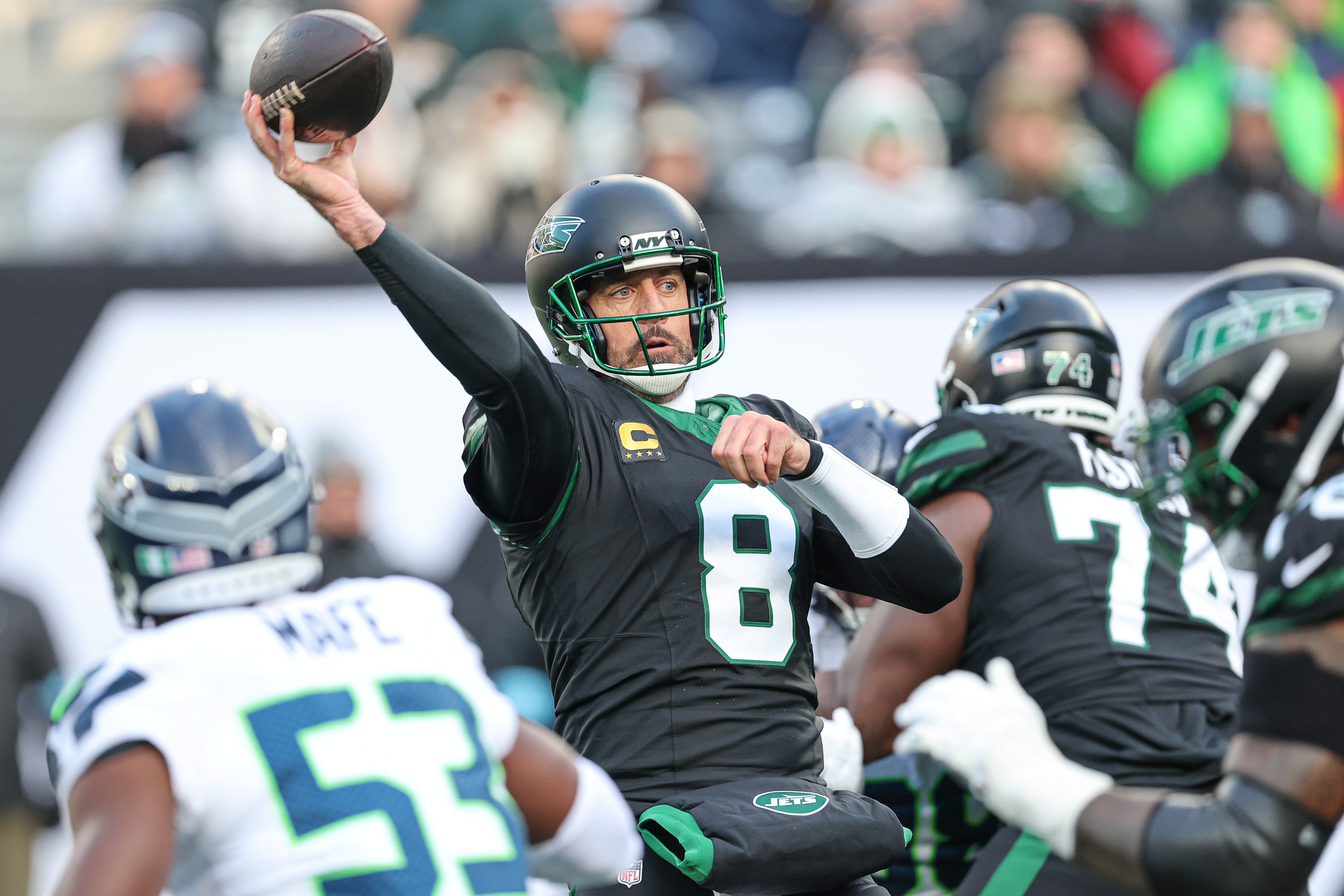 New York Jets quarterback Aaron Rodgers (8) throws the ball during the first half against the Seattle Seahawks at MetLife Stadium.
