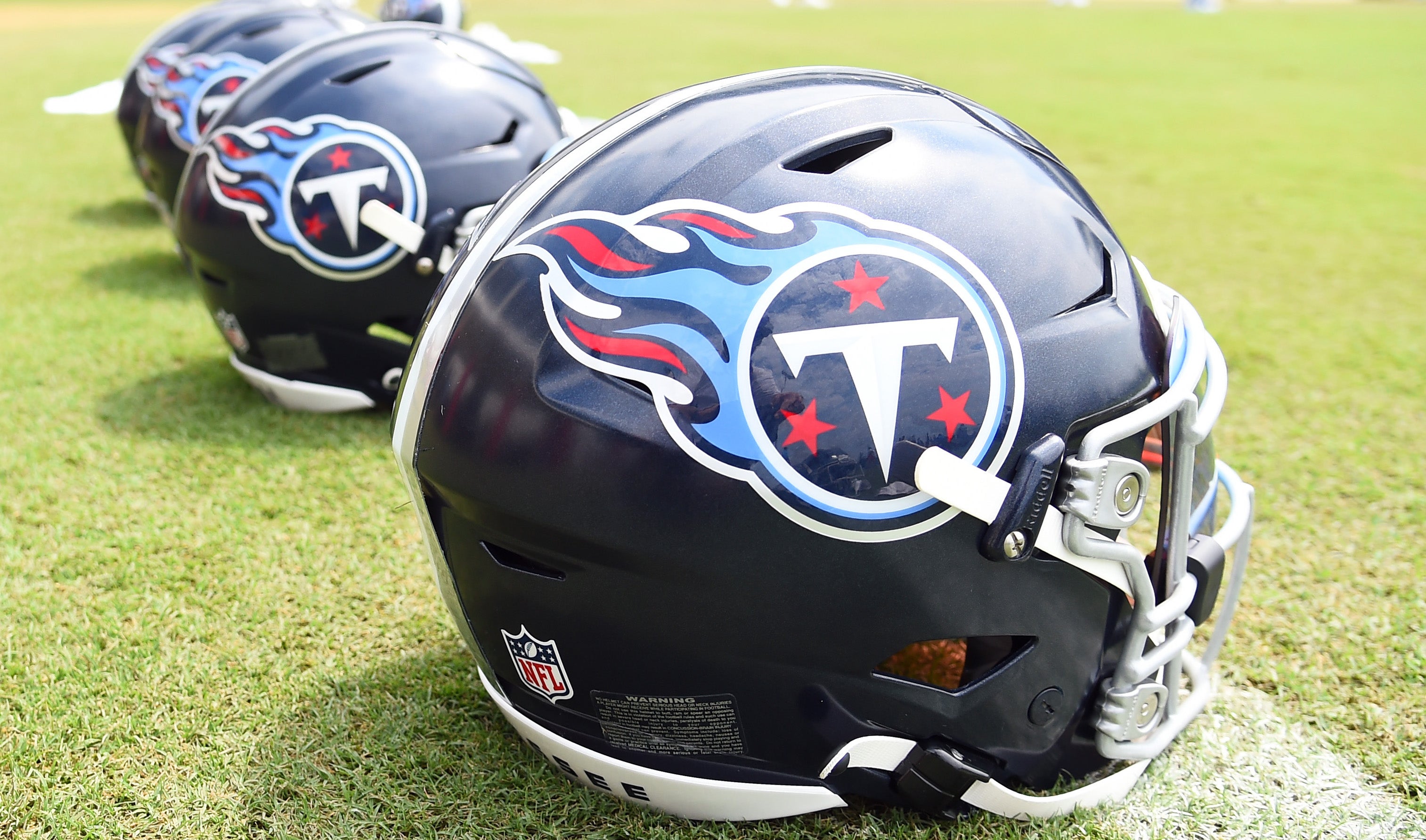 View of helmets on the field as Tennessee Titans players finish training camp practice. Christopher Hanewinckel-Imagn Images