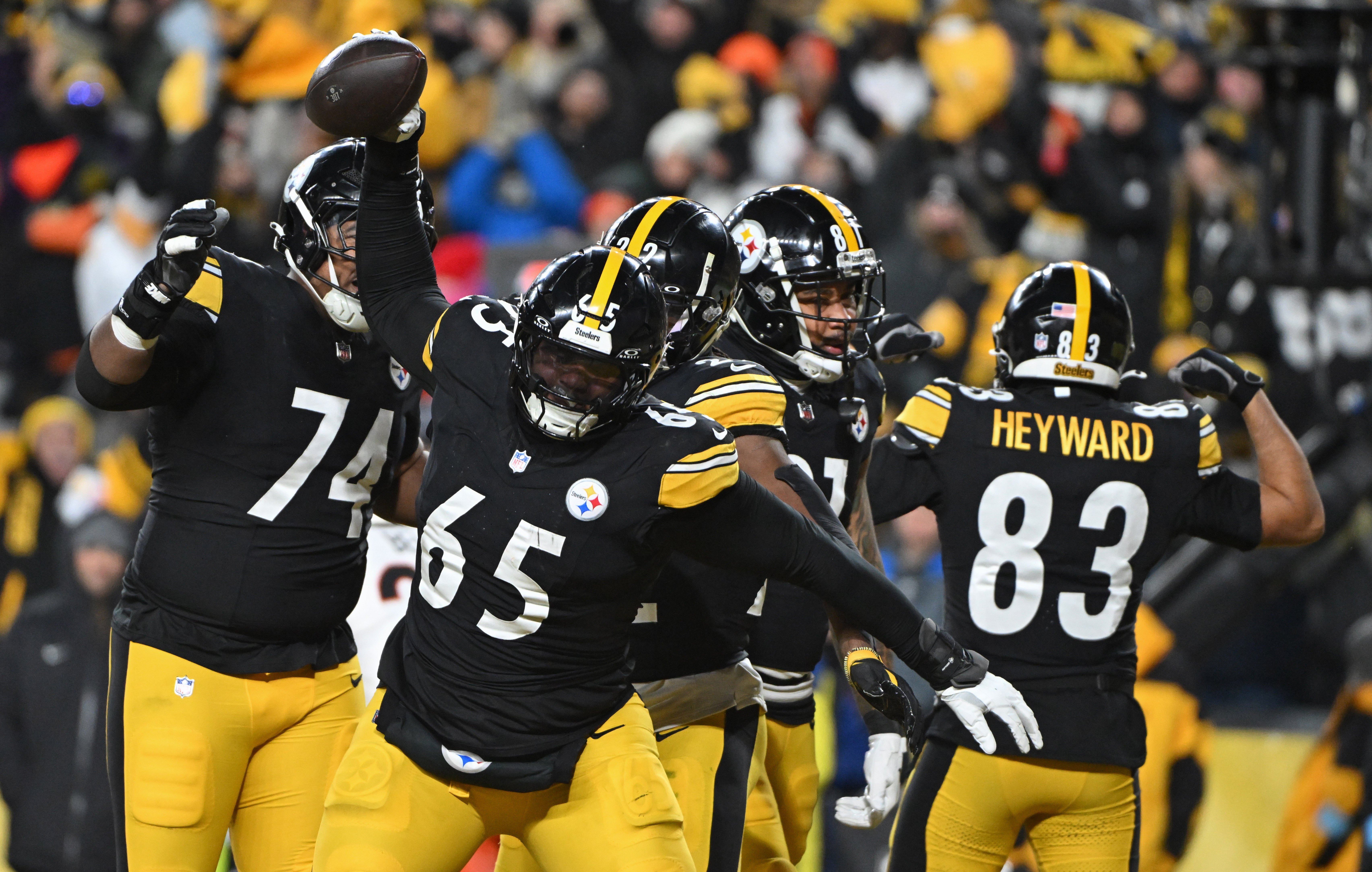 Jan 4, 2025; Pittsburgh, Pennsylvania, USA; Pittsburgh Steelers offensive tackle Dan Moore Jr. (65) celebrates after a touchdown by running back Najee Harris (22) against the Cincinnati Bengals during the second quarter at Acrisure Stadium.