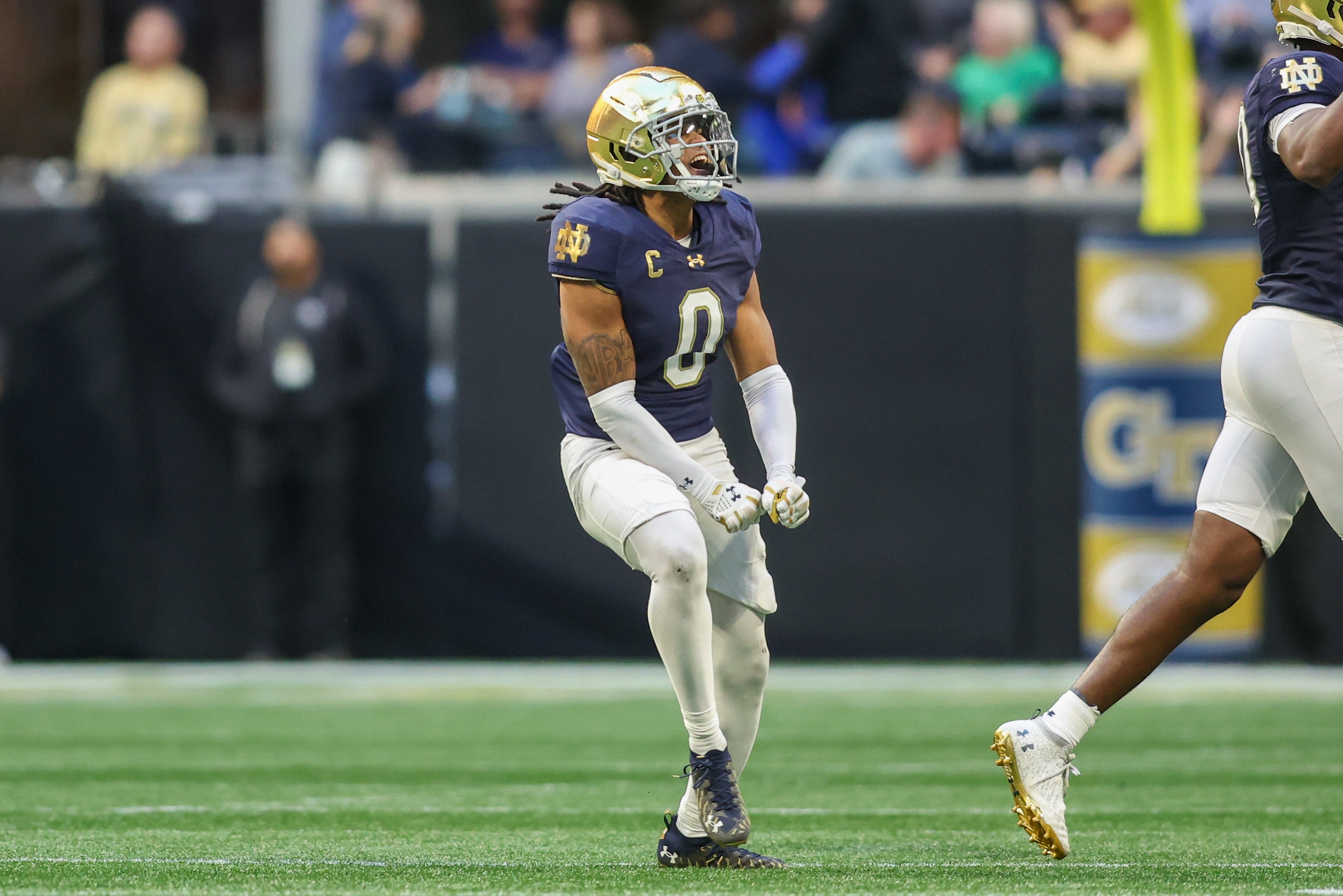 Notre Dame Fighting Irish safety Xavier Watts (0) celebrates after an interception against the Georgia Tech Yellow Jackets in the fourth quarter at Mercedes-Benz Stadium. 