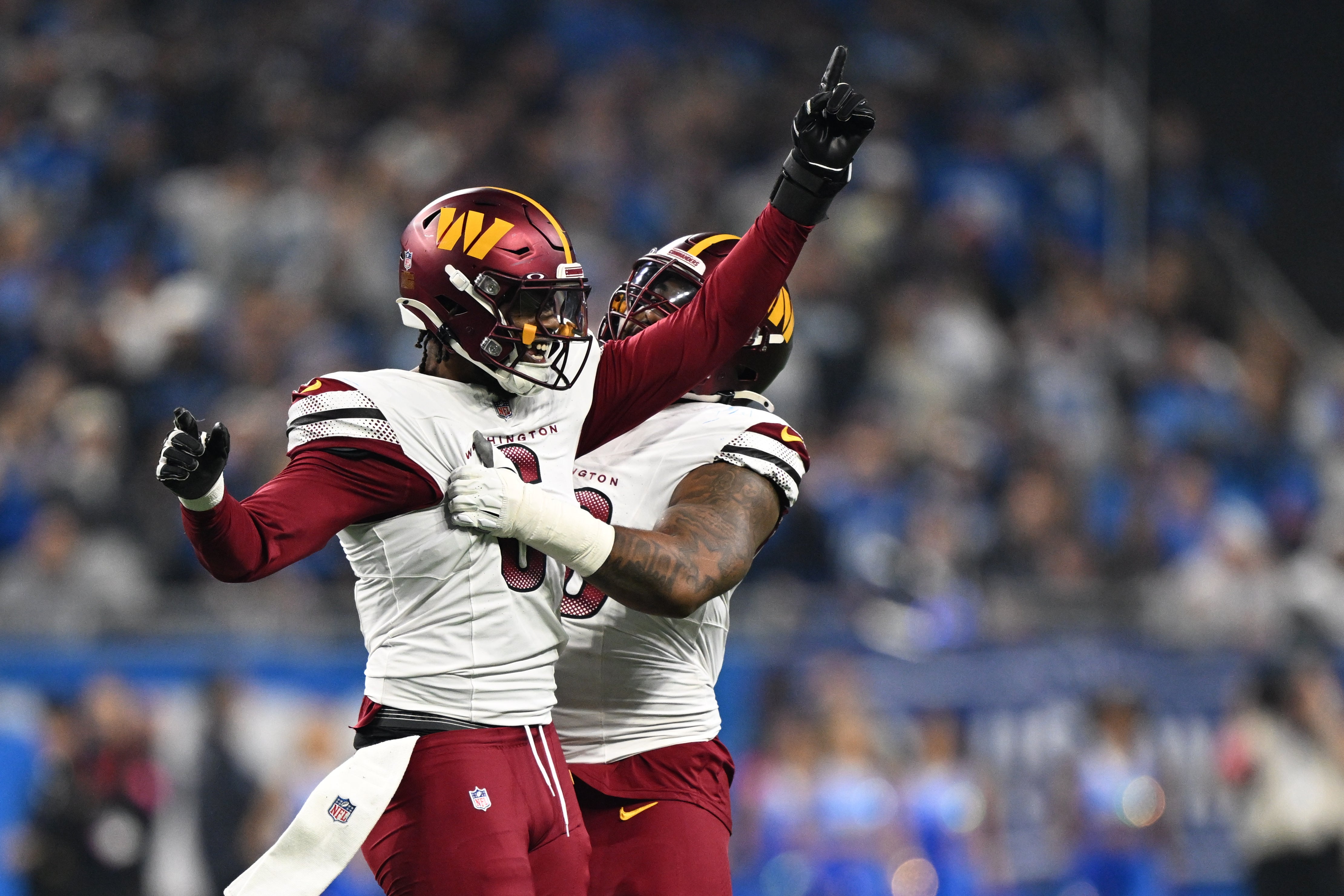 Jan 18, 2025; Detroit, Michigan, USA; Washington Commanders linebacker Dante Fowler Jr. (6) celebrates a recovered fumble with defensive tackle Jonathan Allen (93) during the first quarter against Detroit Lions in a 2025 NFC divisional round game at Ford Field.