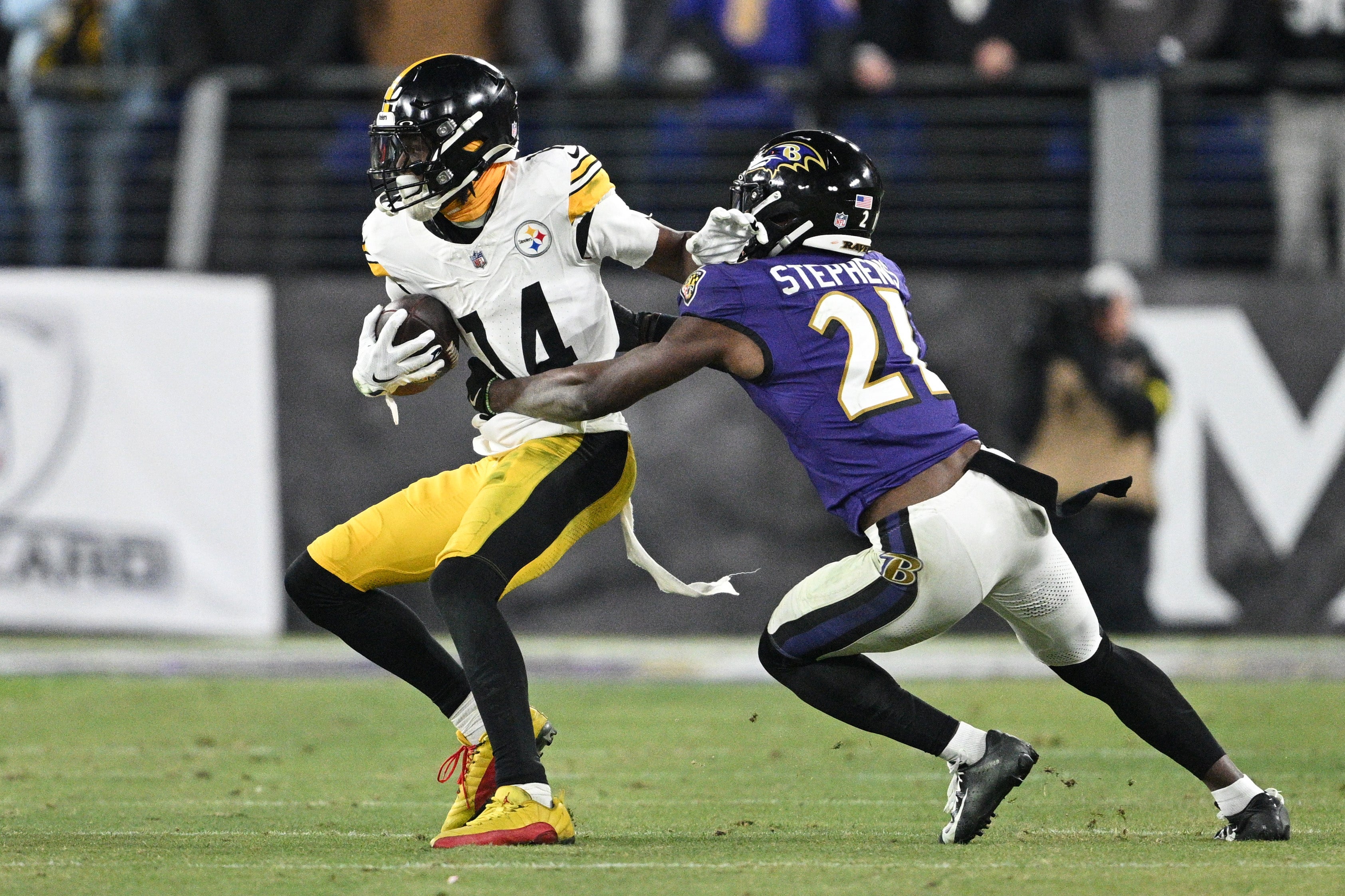 Pittsburgh Steelers wide receiver George Pickens (14) runs against Baltimore Ravens cornerback Brandon Stephens (21) in the fourth quarter in an AFC wild card game at M&T Bank Stadium.
