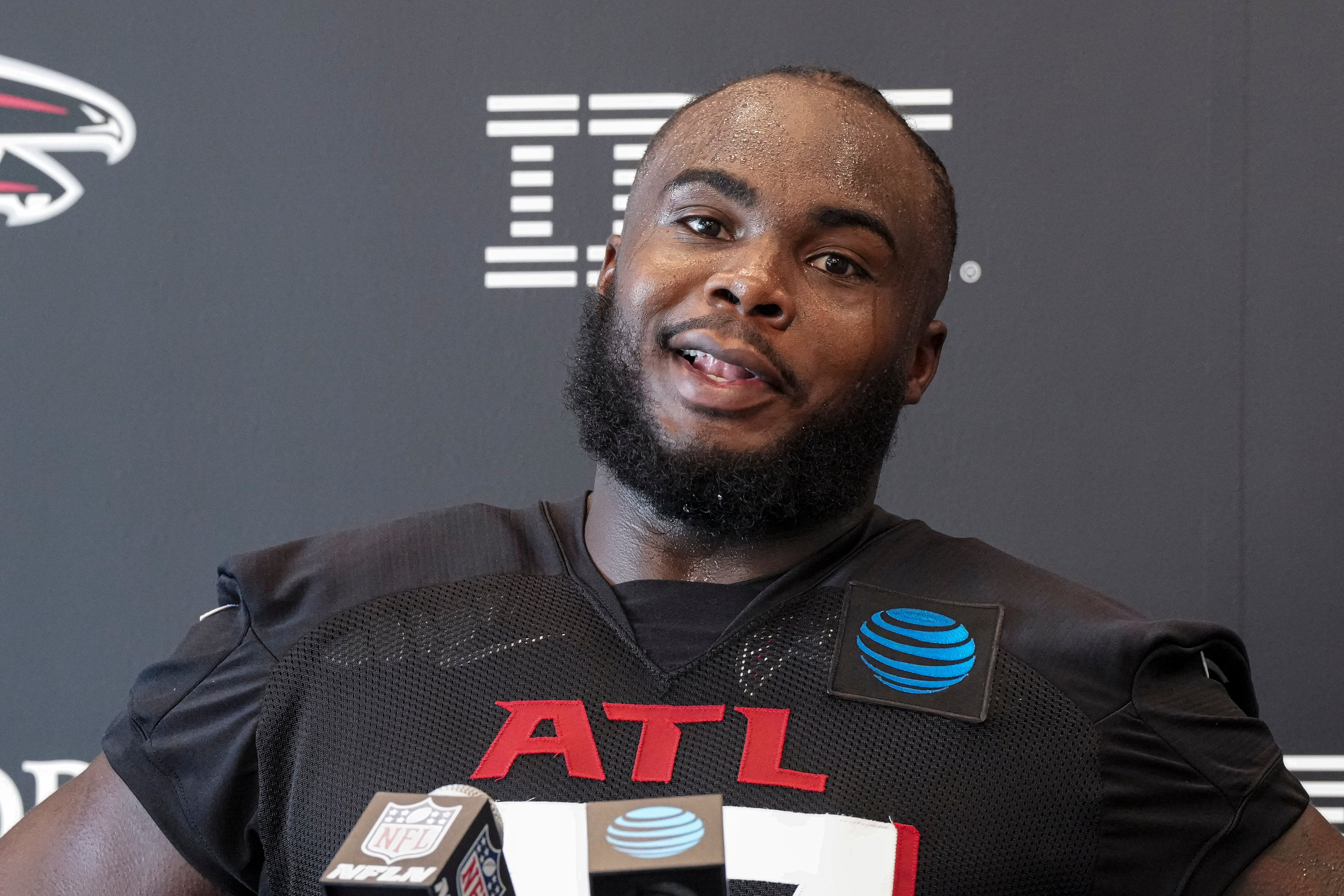 Jul 25, 2024; Buford, GA, USA; Atlanta Falcons defensive end Grady Jarrett (97) talks to the media on the first day of training camp at Falcons Training Camp.