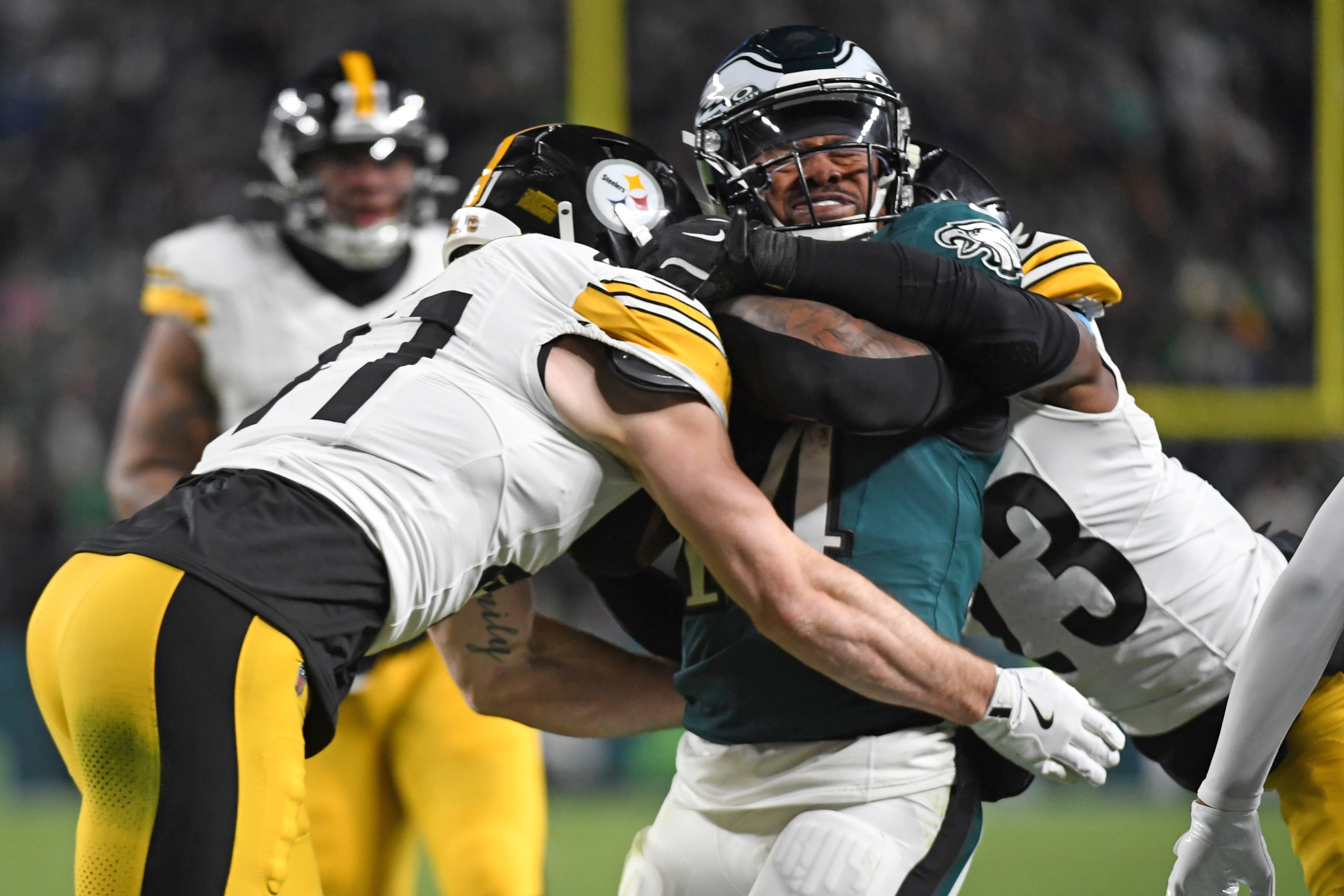 Dec 15, 2024; Philadelphia, Pennsylvania, USA; Philadelphia Eagles running back Kenneth Gainwell (14) is tackled by Pittsburgh Steelers linebacker Payton Wilson (41) and safety Damontae Kazee (23) during the third quarter at Lincoln Financial Field.