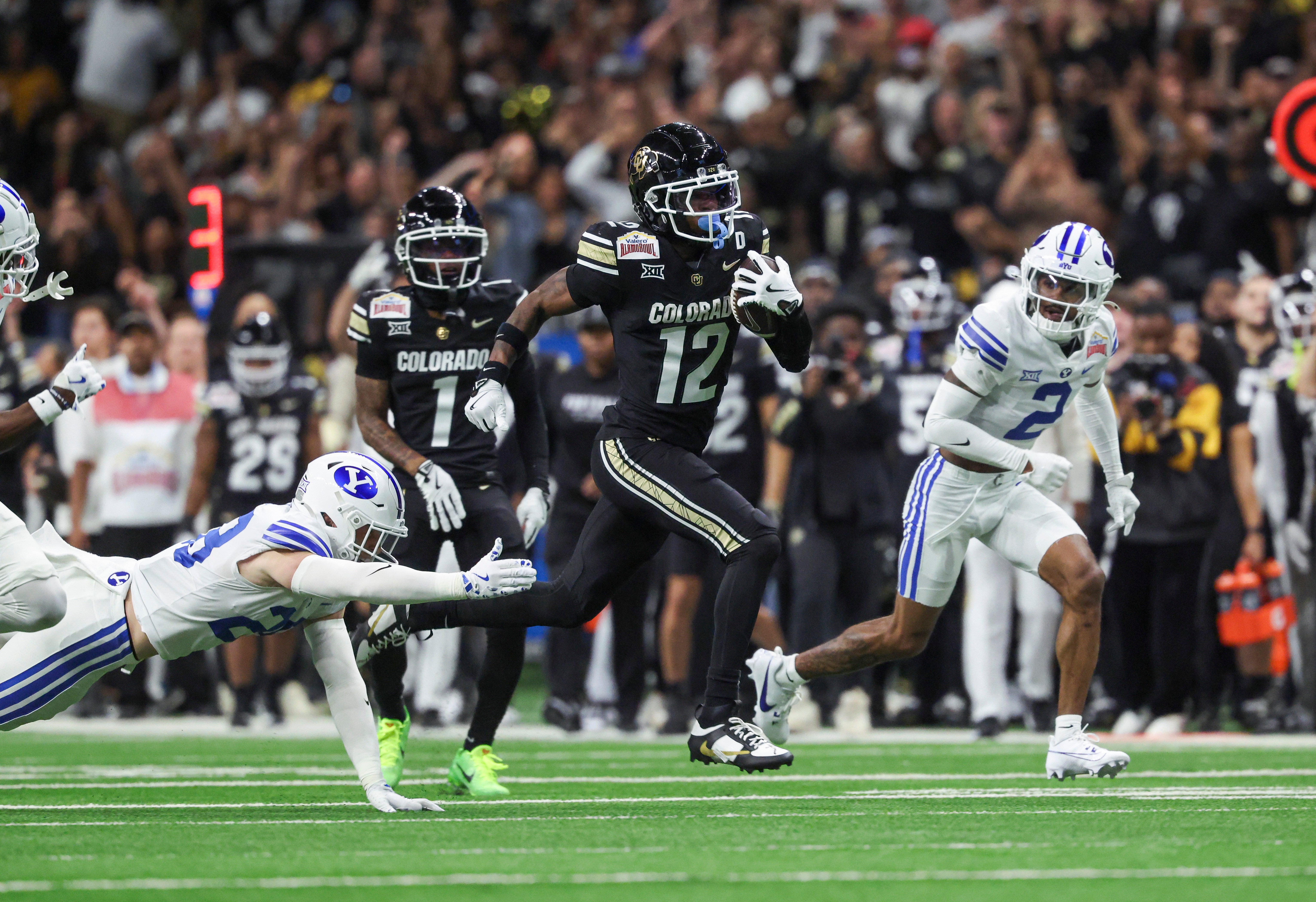 Dec 28, 2024; San Antonio, TX, USA; Colorado Buffaloes wide receiver Travis Hunter (12) runs with the ball during the second quarter against the Brigham Young Cougars at Alamodome.