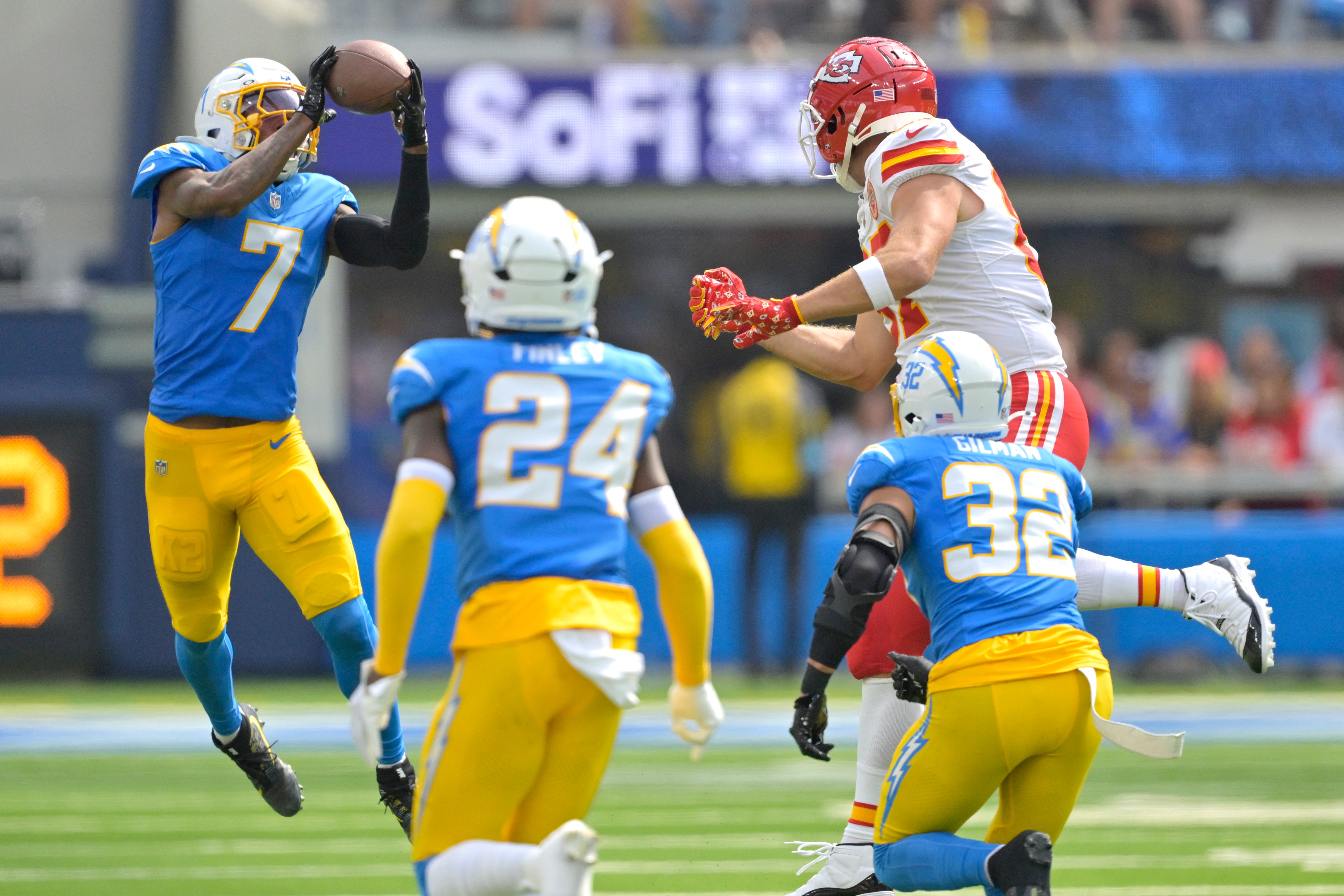 Sep 29, 2024; Inglewood, California, USA; Los Angeles Chargers cornerback Kristian Fulton (7) intercepts a pass intended for Kansas City Chiefs tight end Travis Kelce (87) in the first half at SoFi Stadium.