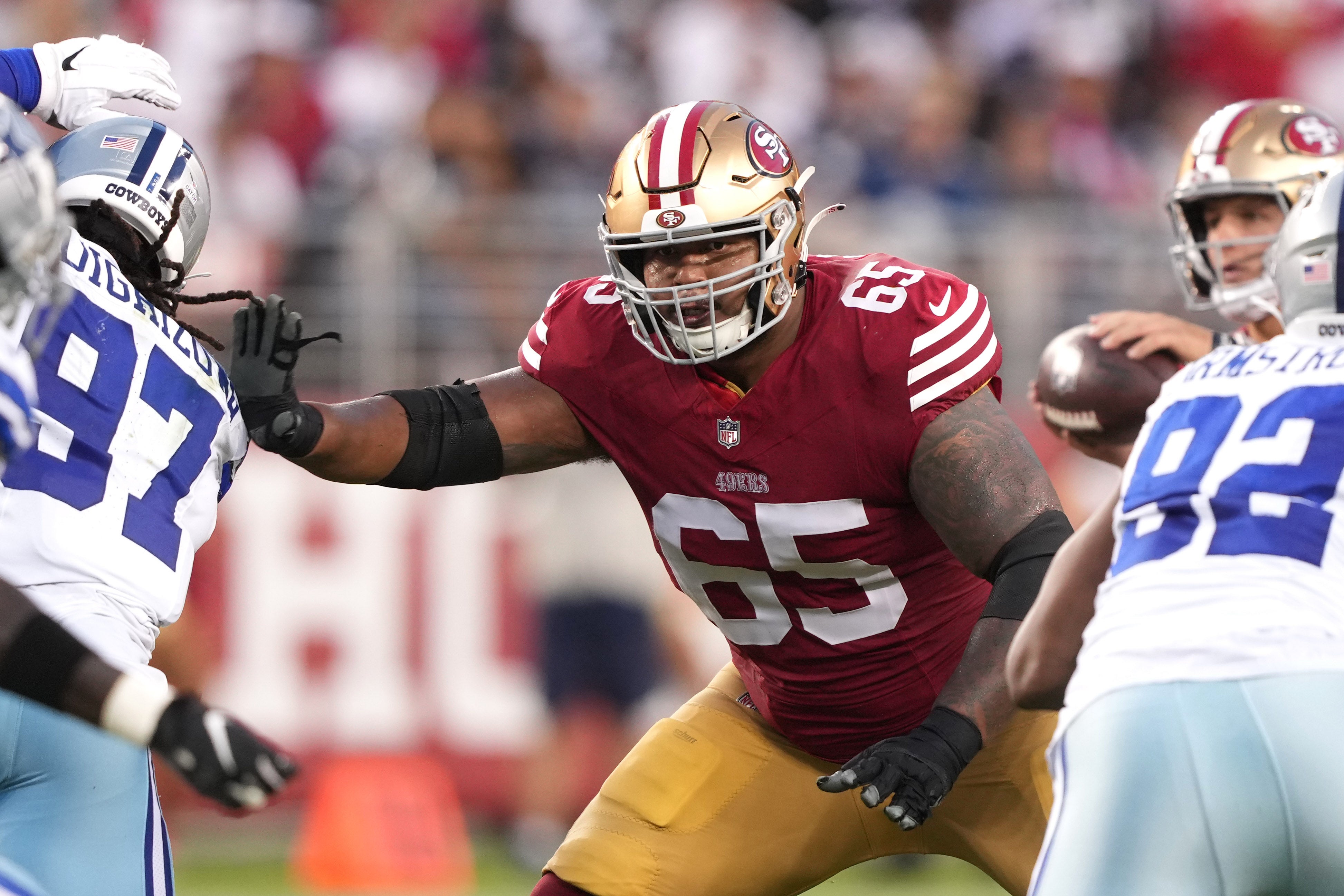 San Francisco 49ers guard Aaron Banks (65) blocks against the Dallas Cowboys during the second quarter at Levi's Stadium.