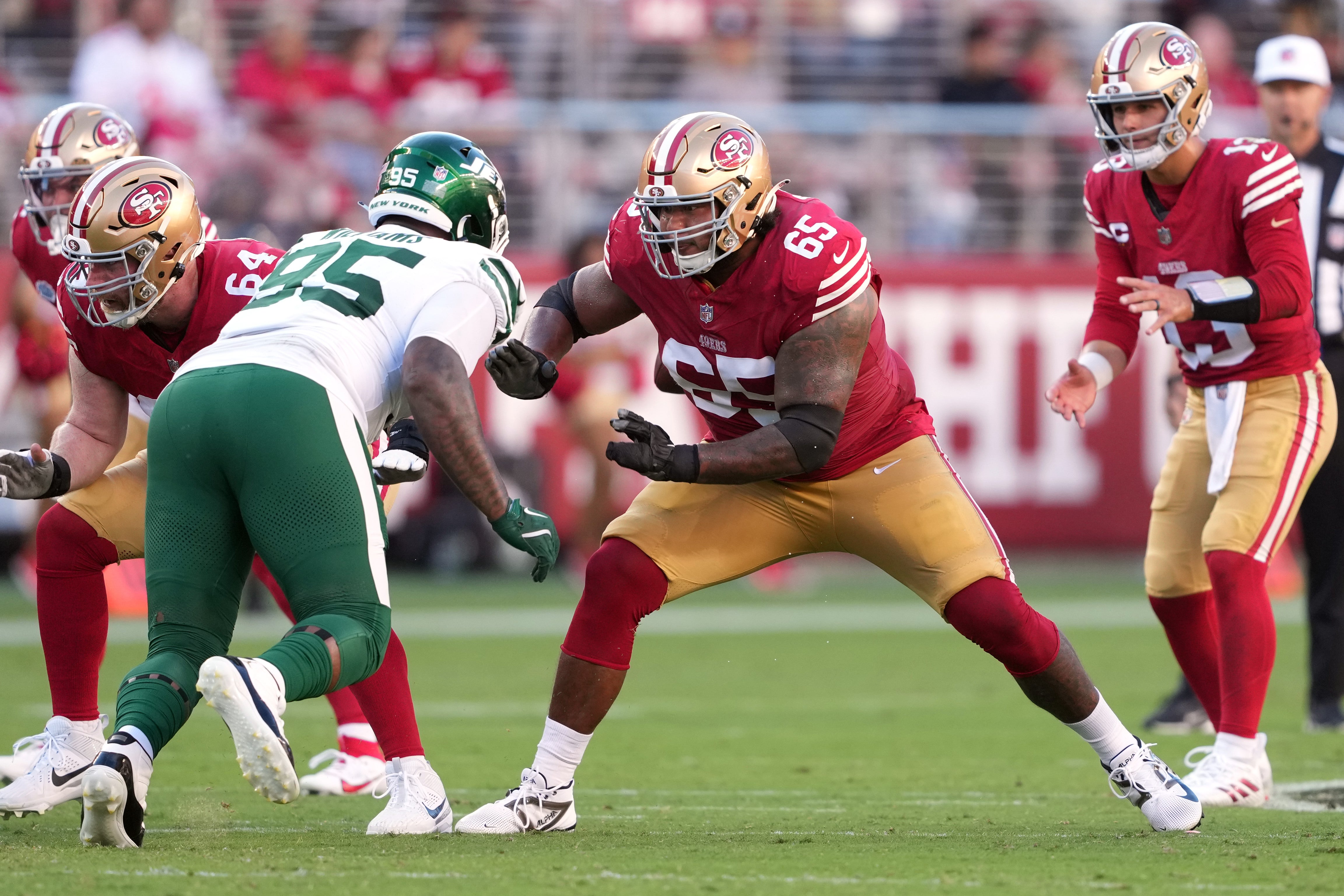 San Francisco 49ers guard Aaron Banks (65) blocks New York Jets defensive tackle Quinnen Williams (center left) during the second quarter at Levi's Stadium.
